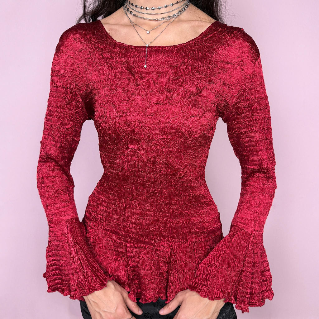 Stunning vintage 2000s burgundy maroon crinkle-pleated blouse featuring dramatic asymmetric bell sleeves, a fitted silhouette, and an asymmetric flared hem. Romantic and avant-garde, ideal for formal parties, festivals, or bold evening wear. Rare archival French design made from polyester by a French brand. Excellent vintage condition.