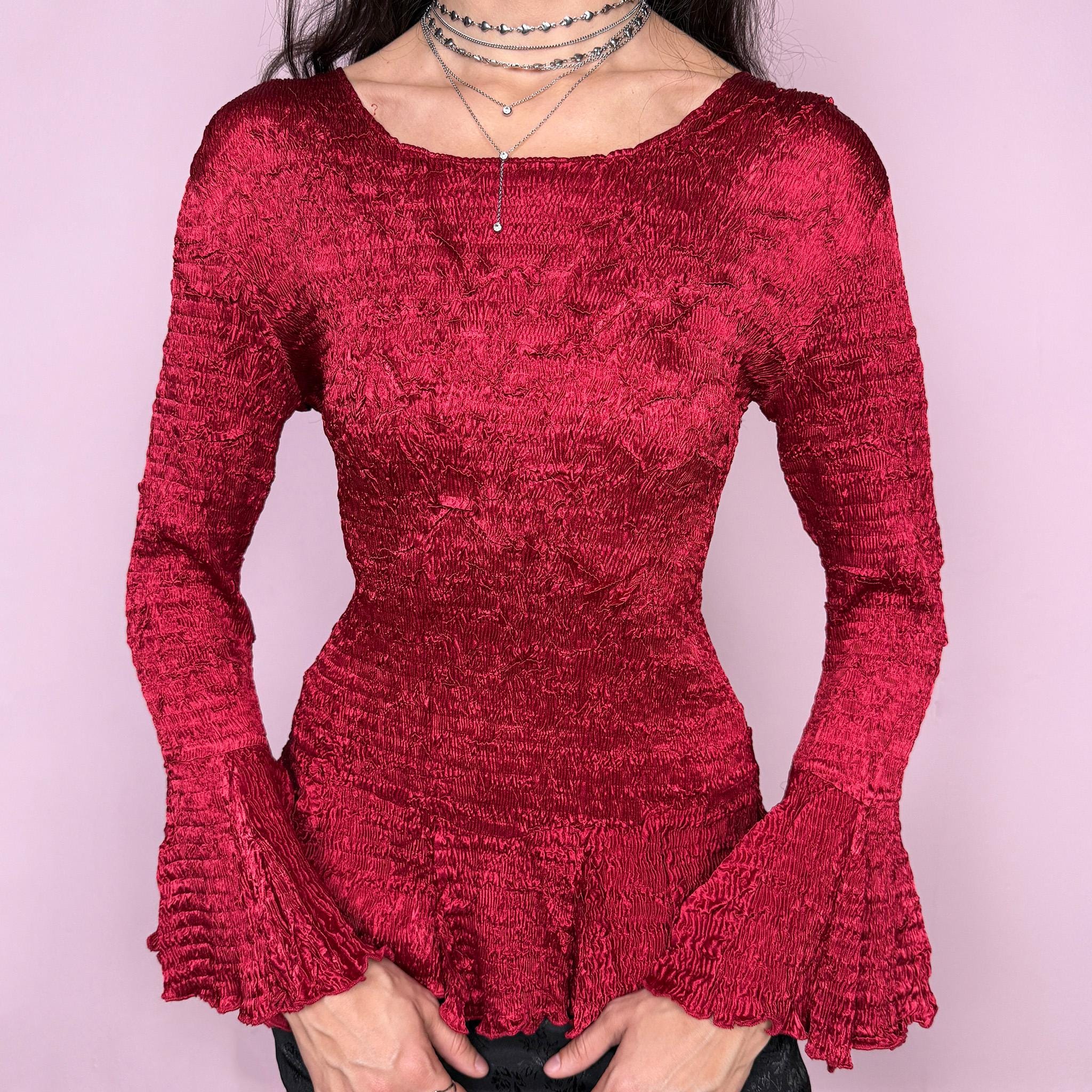 Stunning vintage 2000s burgundy maroon crinkle-pleated blouse featuring dramatic asymmetric bell sleeves, a fitted silhouette, and an asymmetric flared hem. Romantic and avant-garde, ideal for formal parties, festivals, or bold evening wear. Rare archival French design made from polyester by a French brand. Excellent vintage condition.