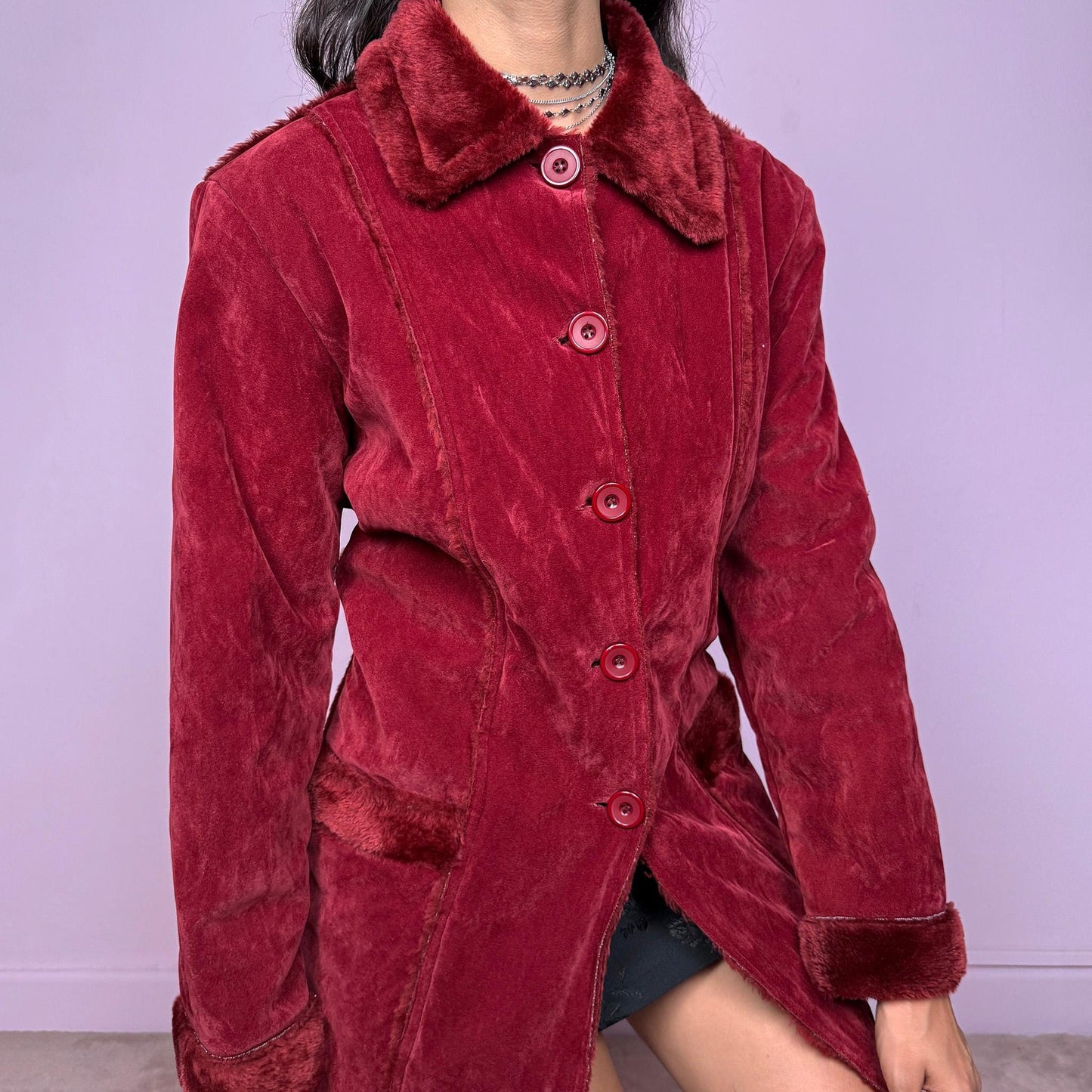 This vintage 2000s red faux suede coat features a plush faux fur lining, collar, and cuffs inspired by the iconic Penny Lane silhouette. Designed with front pockets and button closure, it captures whimsical Y2K winter charm with a boho-grunge edge, perfect for festivals or statement cold-weather styling. Made from polyester faux suede and faux fur. Great vintage condition.