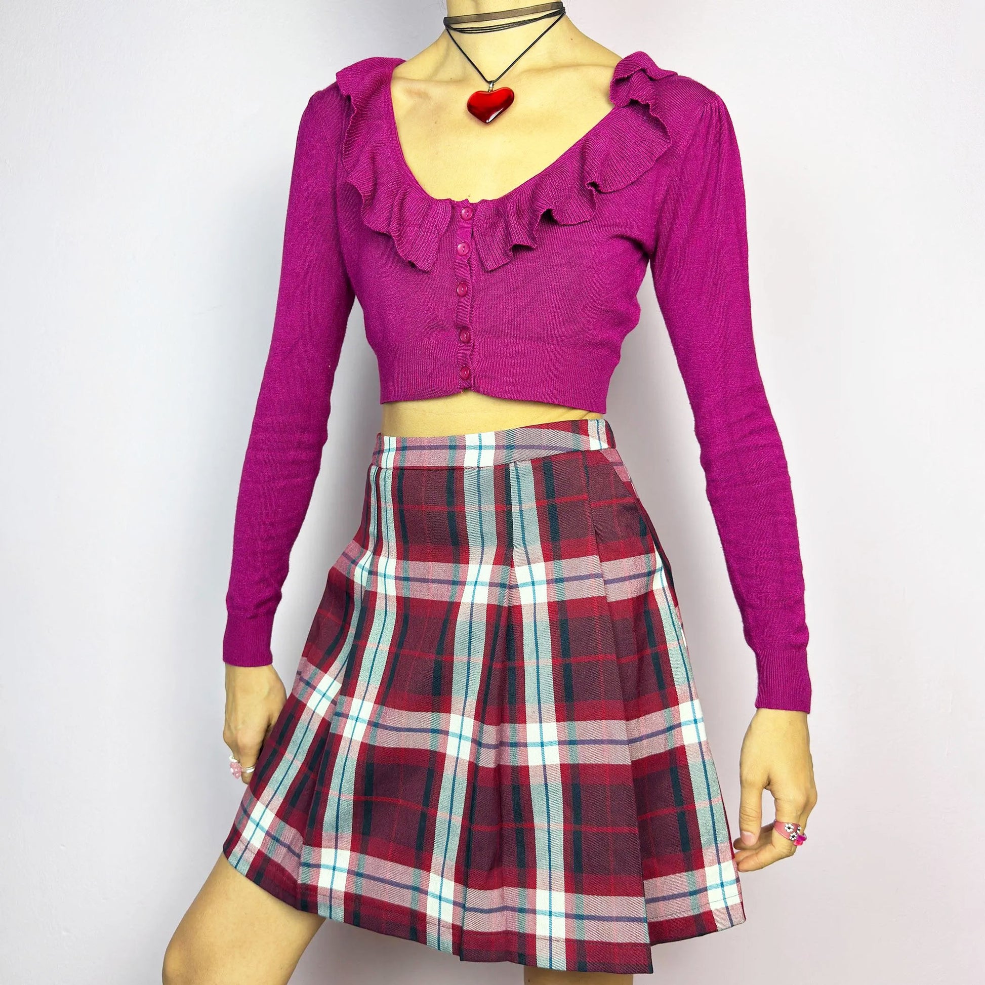 The Y2K Red Plaid Pleated Mini Skirt is a vintage 2000s essential featuring a structured pleated design in a bold red, navy, and white plaid pattern. Made from a woven fabric, it’s perfect for preppy, punk, or casual outfits. It has a back zipper closure and pockets, making it an ideal piece for autumn wardrobe.