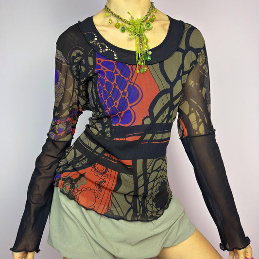 The Y2K Abstract Printed Mesh Top is a vintage 2000s sheer long-sleeve top featuring a bold abstract print in earthy tones with pops of red and blue. Designed with contrast black mesh sleeves, this artistic piece is perfect for edgy streetwear, cyberpunk, or grunge-inspired outfits. Ideal for layering or wearing solo for a statement look. adult world shop