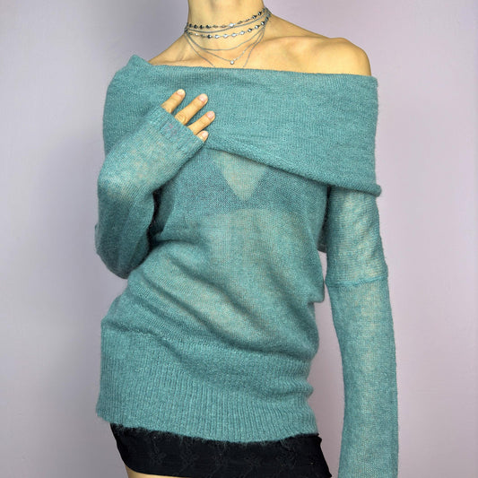 The Y2K Blue Off-Shoulder Sweater is a vintage 2000s cozy and comfy piece made from a mohair, wool, and nylon blend. This soft, semi-sheer sweater features a folded off-shoulder neckline and a muted blue hue. adult world shop