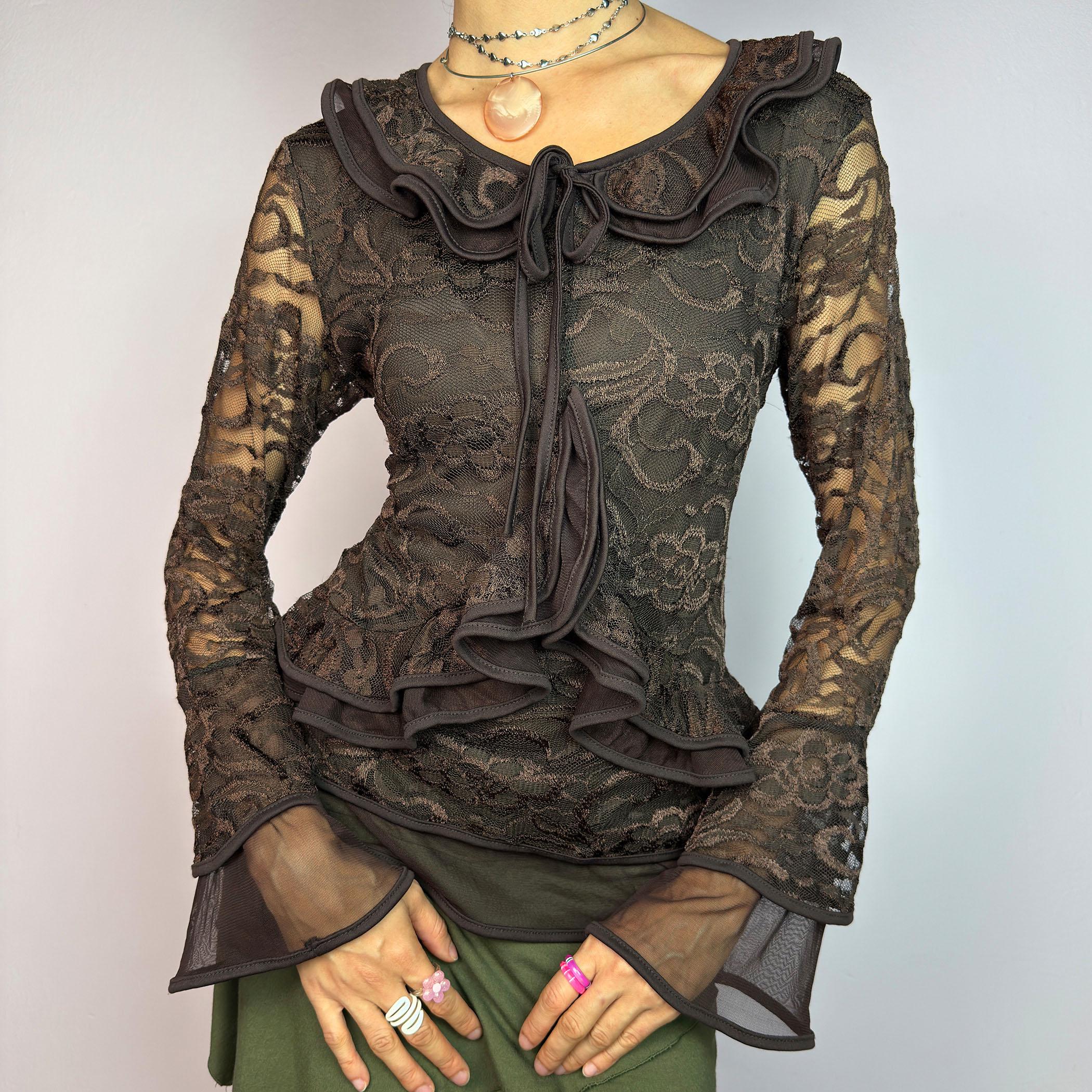 The Y2K Brown Lace Ruffle Top is a vintage 2000s statement piece, showcasing intricate floral lace throughout for a romantic and feminine look. This top features a stretchy semi-sheer fabric, layered ruffles along the neckline. adult world shop
