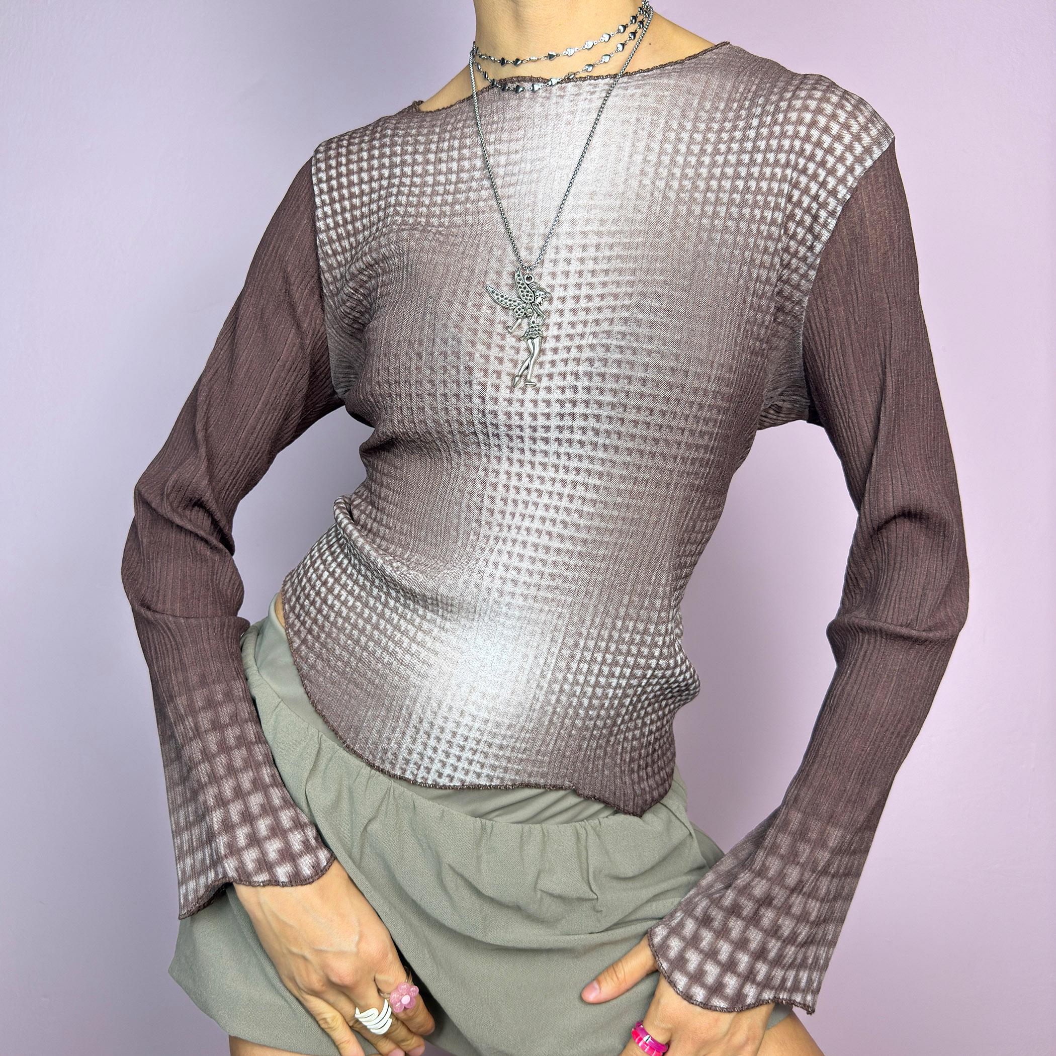 The Y2K Brown Ombre Gradient Top is a vintage 2000s semi-sheer stretchy top featuring a unique ombre gradient print that fades from deep brown to a soft beige. Designed with a subtle asymmetric cut, ribbed texture, and long sleeves, this statement piece adds a futuristic yet earthy touch to casual and streetwear outfits. Perfect for a sleek, edgy look. adult world shop