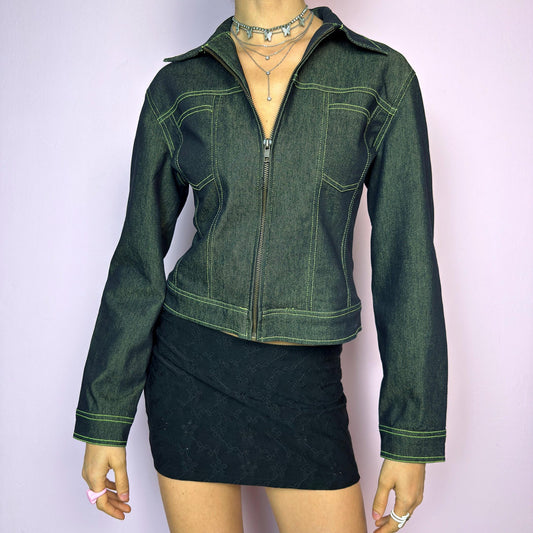 The Y2K Dark Denim Jacket is a vintage 2000s denim piece with a fitted cut and structured silhouette. Crafted in a dark rinse wash that gives it a sleek finish. Features a full front zip closure, bold panel seam construction, and sharp collar. The standout detail? Neon contrast stitching that adds a futuristic, eye-catching touch. A statement layering piece. Excellent vintage condition. adult world shop