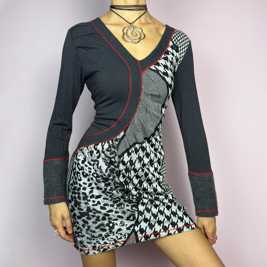 The Y2K Gray Patchwork Mini Dress is a vintage 2000s piece featuring a bold patchwork print with a mix of houndstooth, plaid, and leopard patterns, a V-neckline and long sleeves. The fitted silhouette. adult world shop