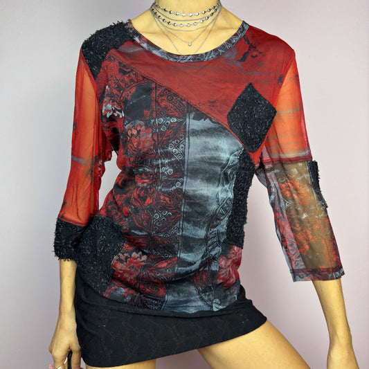 The Y2K Patchwork Print Mesh Top is a vintage 2000s statement piece featuring a semi-sheer patchwork design with a mix of mesh, printed fabric, and textured appliqué details. Designed with a round neckline, 3/4 length sleeves, and contrast fabric patches, this edgy top is perfect for alternative, cyber, or grunge-inspired outfits. adult world shop