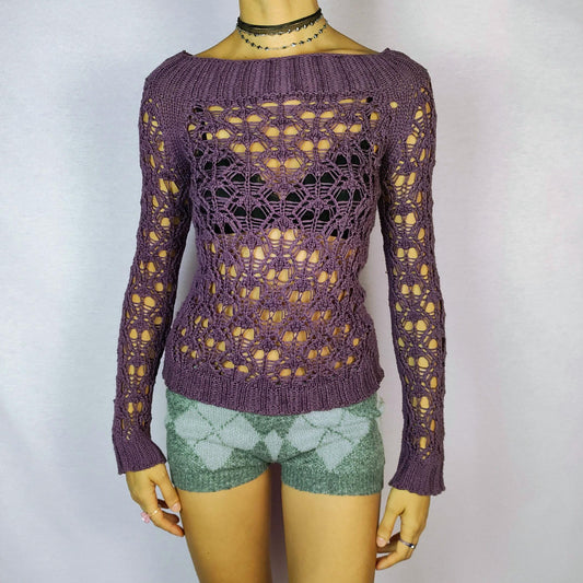 The Y2K Purple Crochet Boat Sweater is a vintage 2000s pullover featuring an intricate crochet-knit design, a boat neckline and long sleeves.
