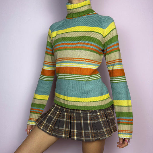 The Y2K Striped Turtleneck Sweater is a vintage 2000s classic featuring a cozy ribbed turtleneck design. Crafted from a knit fabric, it showcases bold multicolor horizontal stripes. adult world shop