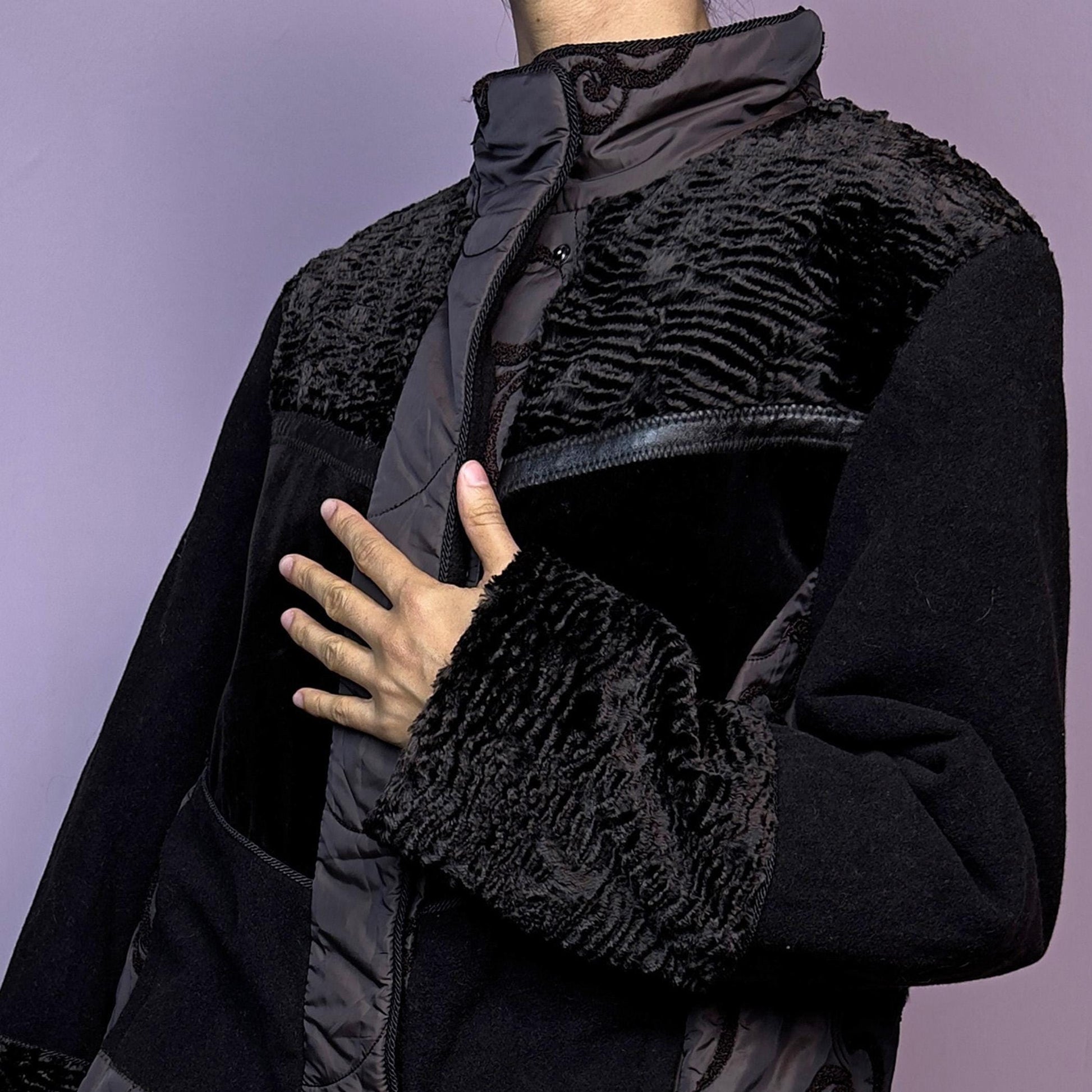 The Y2K Brown Contrast Panel Jacket is a vintage 2000s piece featuring a striking mixed-material design in dark brown with textured panels, including quilted, faux fur, and velvety fabric sections. It comes with a zipper and snap button closure
