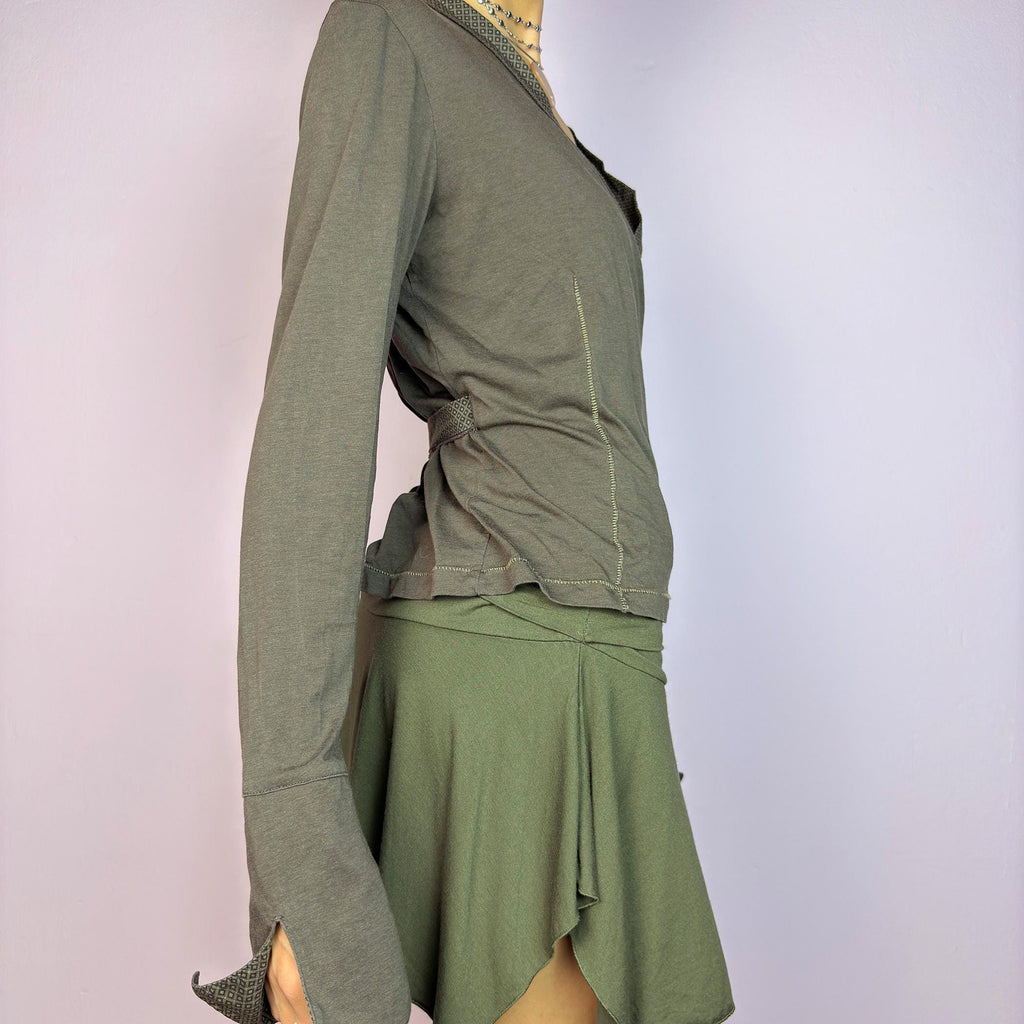 The Y2K Brown Wrap Cop Copine Top is a sleek and minimalist 2000s piece featuring a wrap-tie design with geometric-patterned trim details and flared cuffs. This top is crafted from a stretchy, comfortable fabric. adult world shop