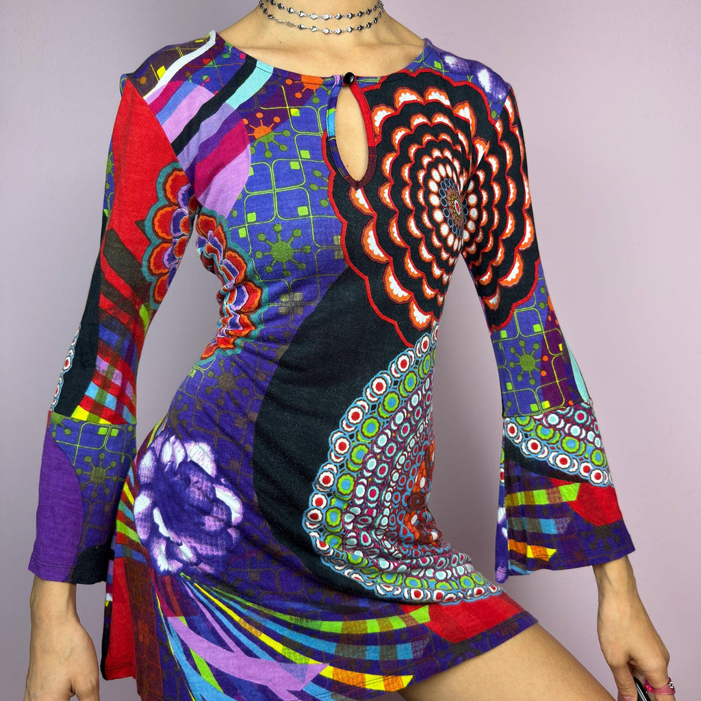 The Y2K Psychedelic Print Mini Dress is a statement 2000s piece, featuring a bold and colorful abstract pattern with a mix of geometric and floral designs and is crafted from a stretchy fabric. adult world shop