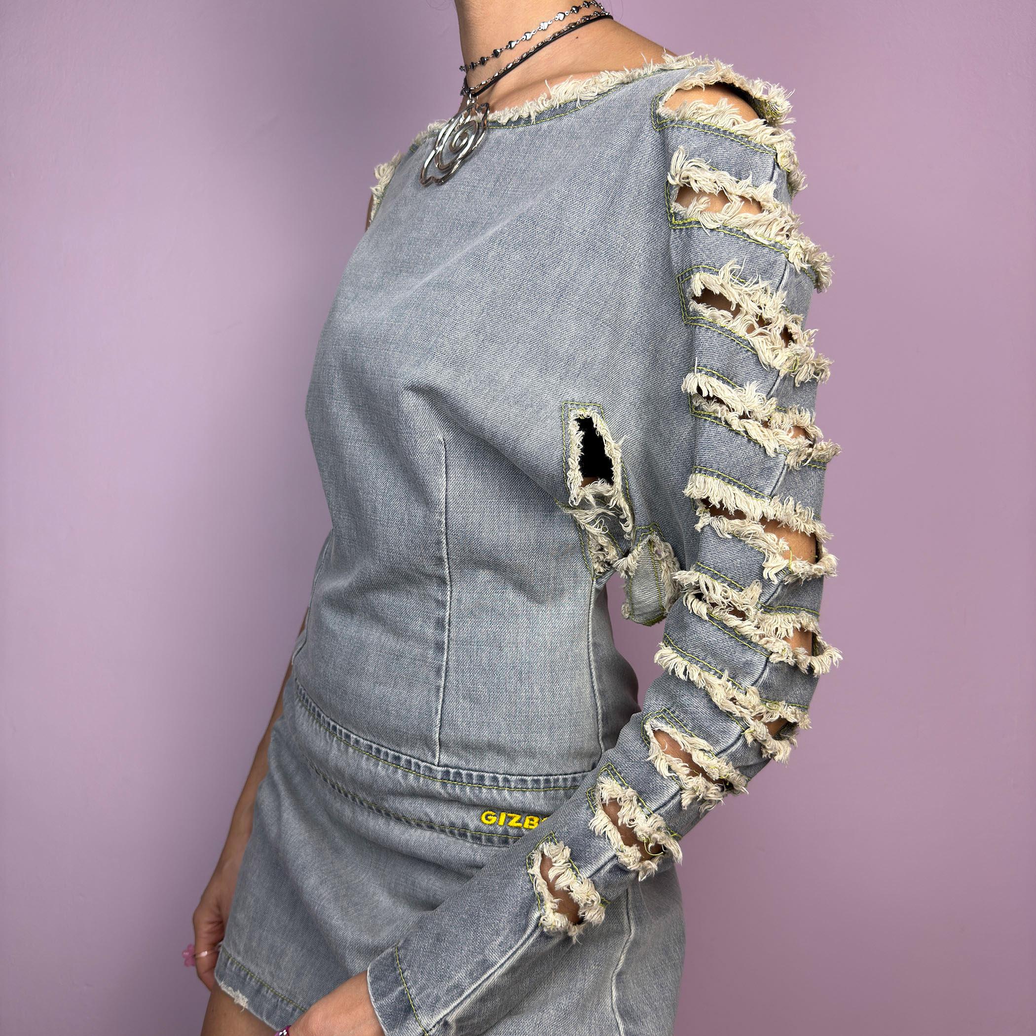 The Y2K Distressed Denim Mini Dress is an edgy statement 2000s piece featuring a raw-cut, asymmetrical design with a structured fit and a side zipper closure. Made from vintage-wash denim, this dress has a deconstructed aesthetic. adult world shop