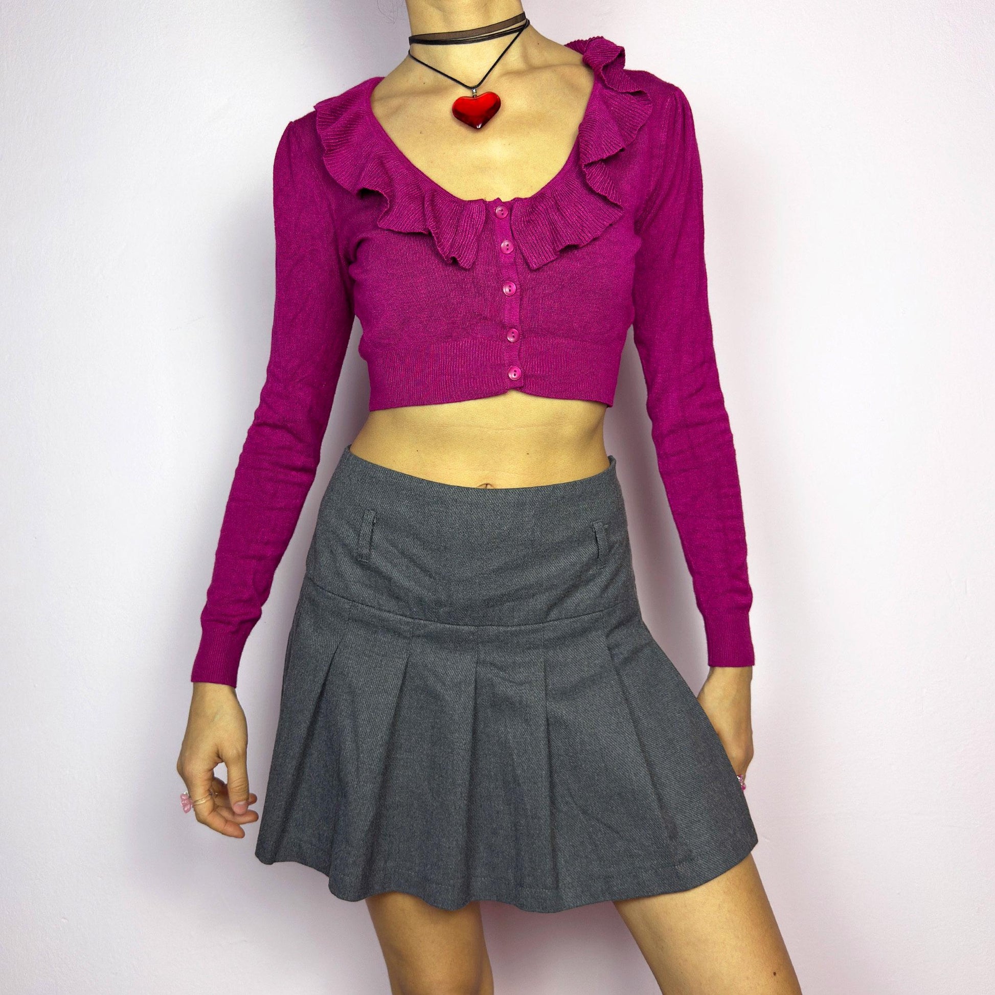 The Y2K Gray Pleated Mini Skirt is a vintage 2000s essential, featuring a structured pleated design and a side zipper closure. Made from a thick woven fabric, is perfect for preppy, grunge, or casual outfits. adult world shop