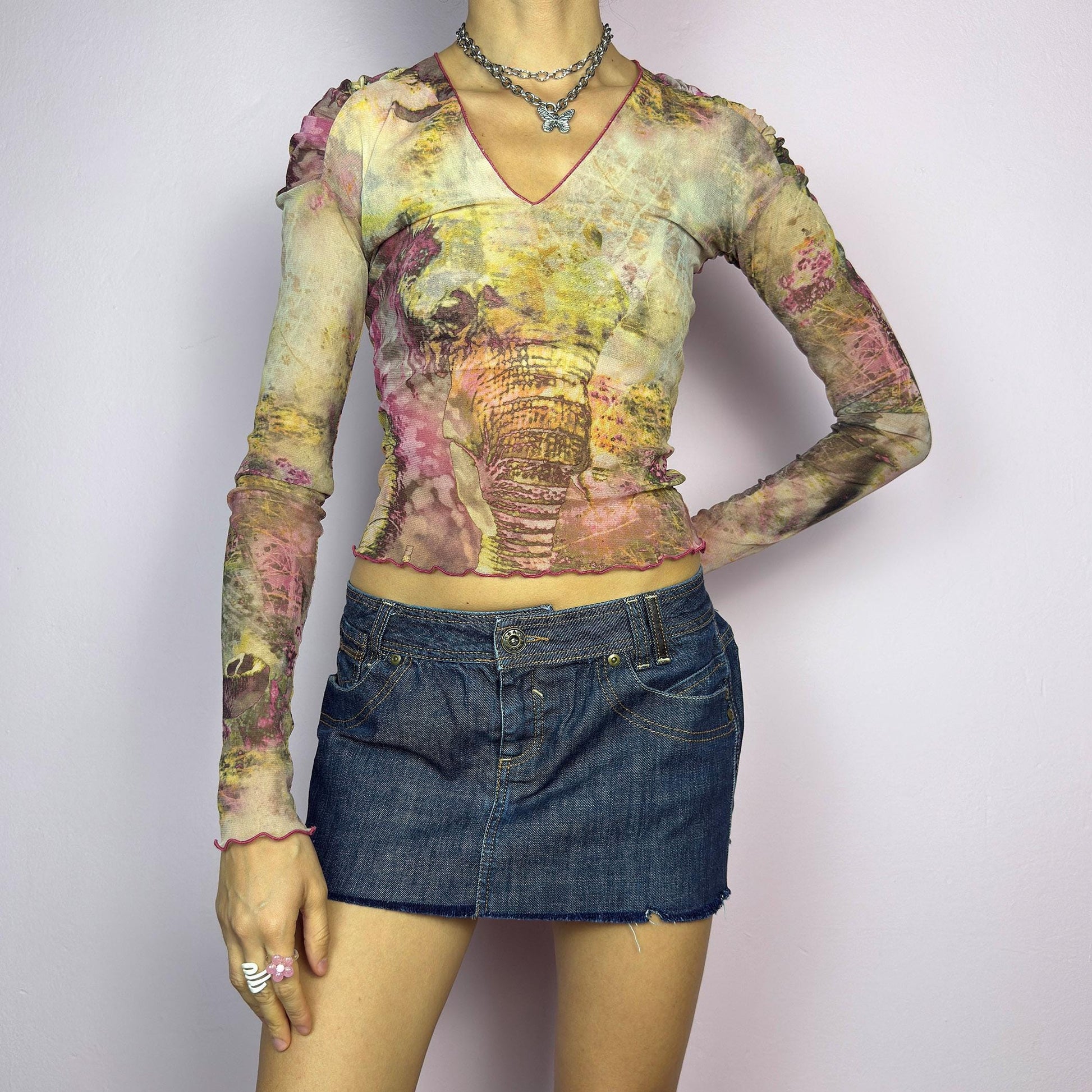 The Y2K Dark Denim Low-Rise Micro Mini Skirt is a vintage 2000s staple, featuring a short micro fit with a low-rise waist and a raw hem for an effortlessly edgy look. Crafted from dark-wash denim with contrast stitching. adult world shop