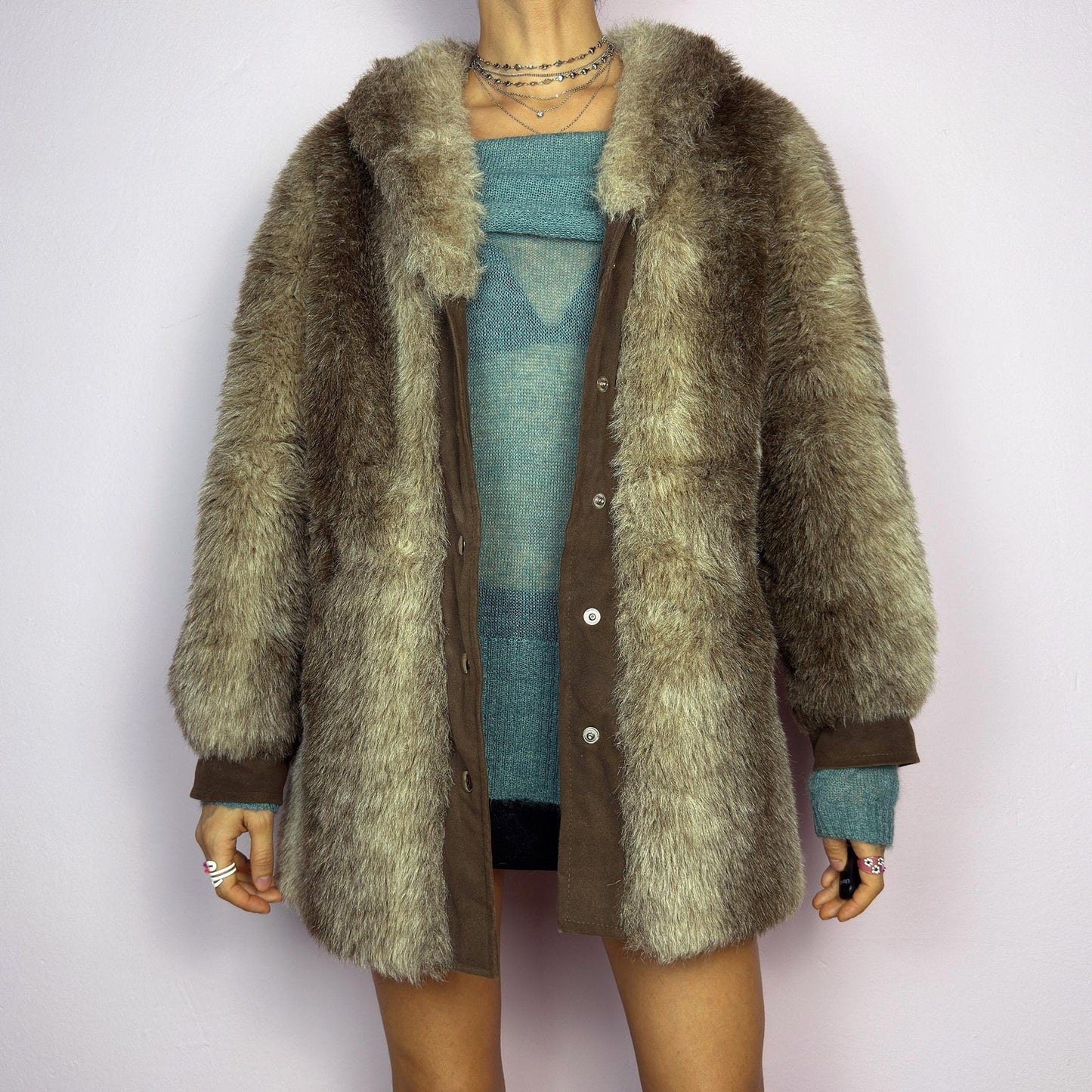 The Vintage 90s Plush Faux Fur Coat is a statement outerwear piece exuding warmth and glamour. This coat features a plush faux fur texture in earthy tones, creating a cozy look. Designed with a snap button-front closure. adult world shop