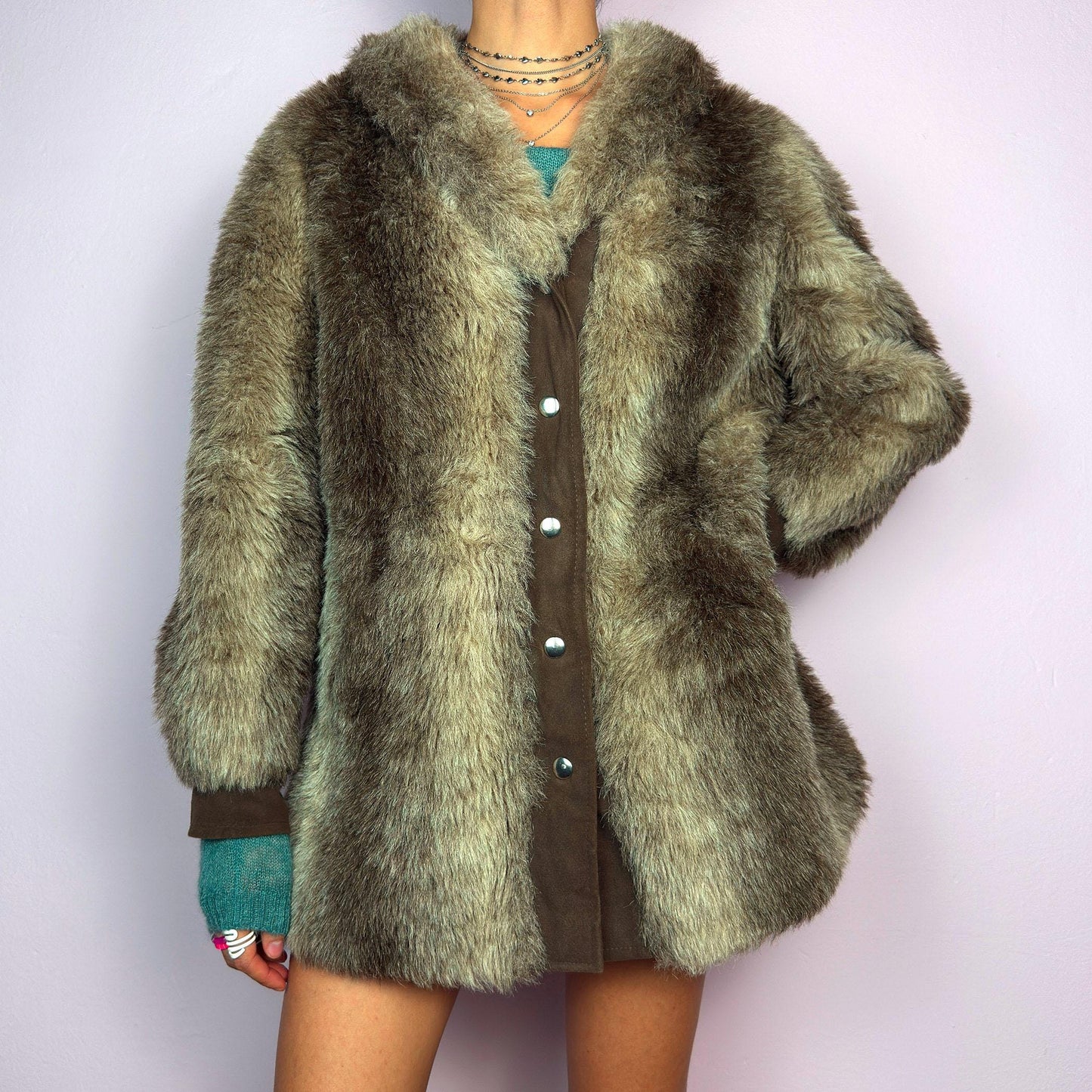 The Vintage 90s Plush Faux Fur Coat is a statement outerwear piece exuding warmth and glamour. This coat features a plush faux fur texture in earthy tones, creating a cozy look. Designed with a snap button-front closure. adult world shop