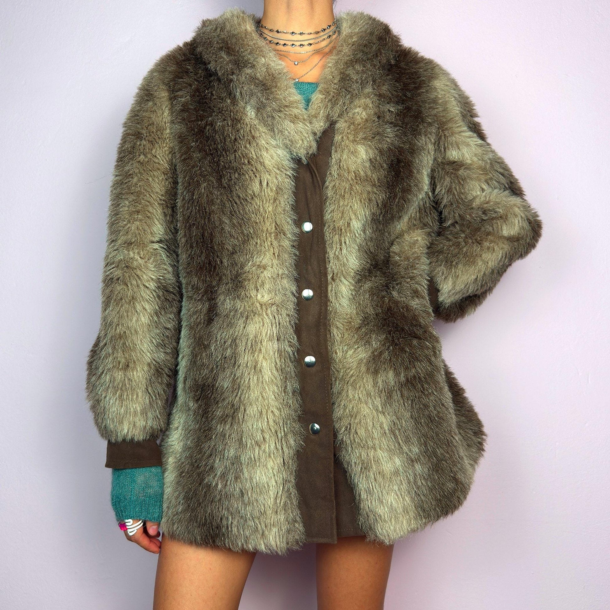 The Vintage 90s Plush Faux Fur Coat is a statement outerwear piece exuding warmth and glamour. This coat features a plush faux fur texture in earthy tones, creating a cozy look. Designed with a snap button-front closure. adult world shop