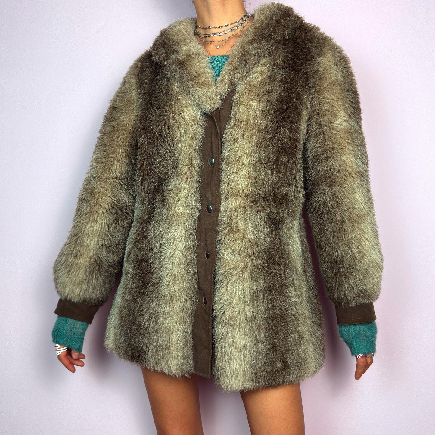 The Vintage 90s Plush Faux Fur Coat is a statement outerwear piece exuding warmth and glamour. This coat features a plush faux fur texture in earthy tones, creating a cozy look. Designed with a snap button-front closure. adult world shop