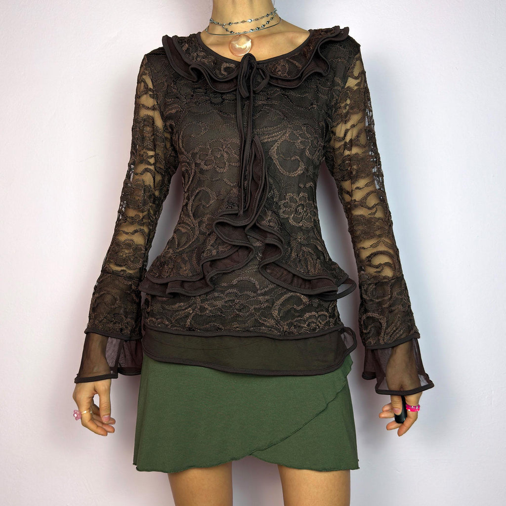 The Y2K Brown Lace Ruffle Top is a vintage 2000s statement piece, showcasing intricate floral lace throughout for a romantic and feminine look. This top features a stretchy semi-sheer fabric, layered ruffles along the neckline. adult world shop