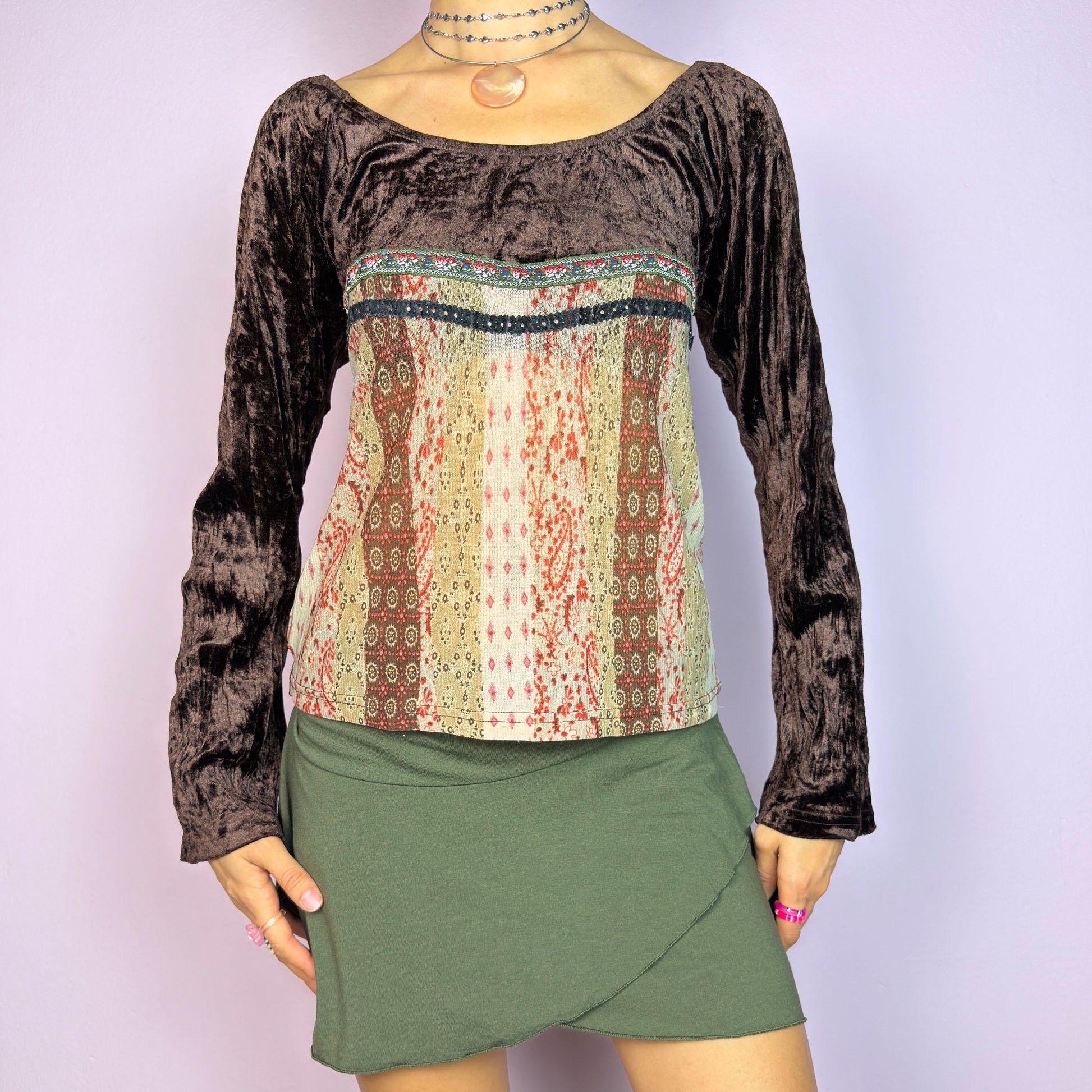 The Y2K Flared Sleeve Mesh Top is a vintage 2000s stretchy piece that combines soft brown velvet bell long sleeves with a printed semi-sheer mesh bodice featuring earthy tones. Perfect for a whimsical inspired look. adult world shop
