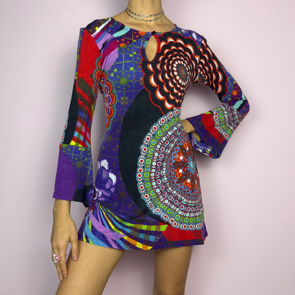 The Y2K Psychedelic Print Mini Dress is a statement 2000s piece, featuring a bold and colorful abstract pattern with a mix of geometric and floral designs and is crafted from a stretchy fabric. adult world shop
