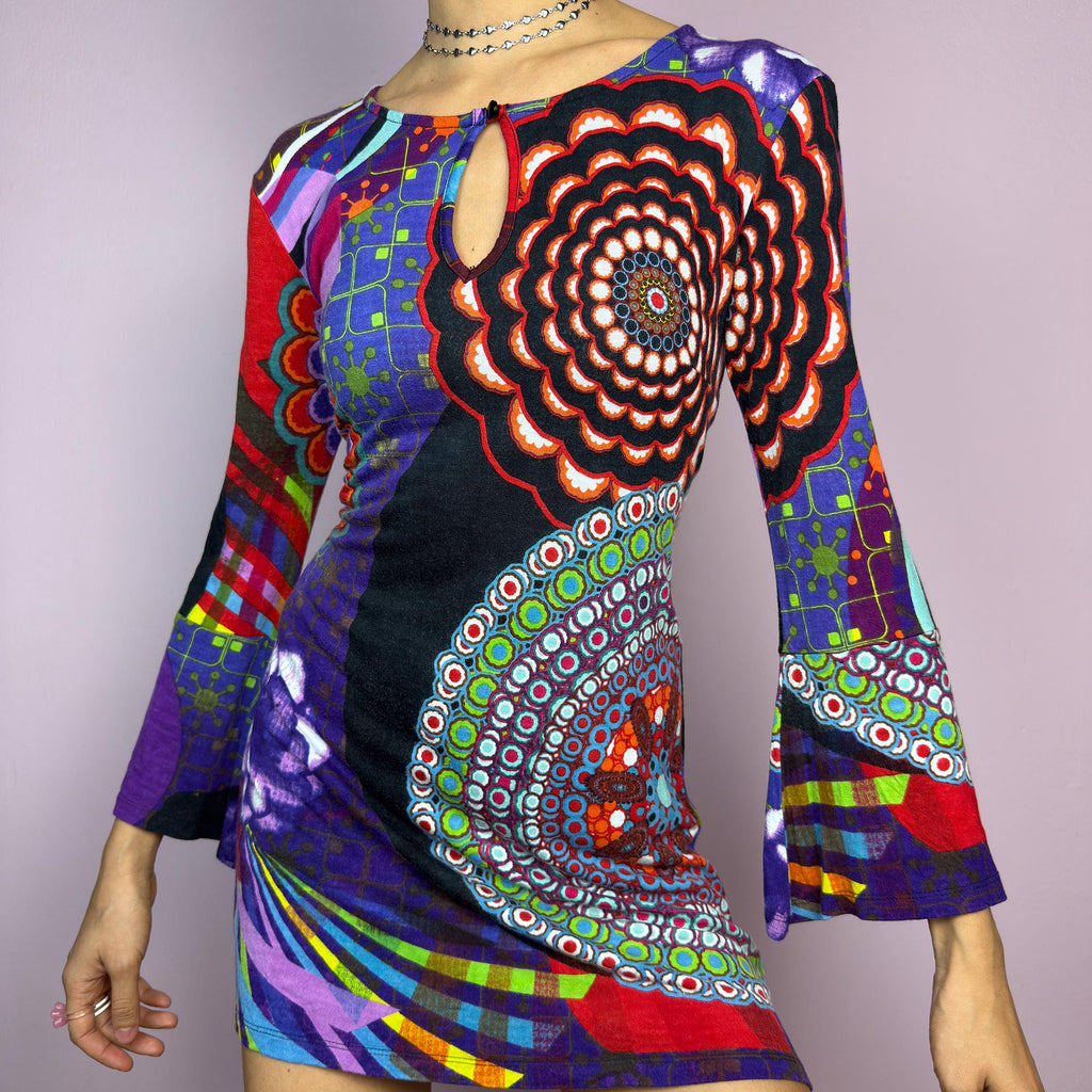 The Y2K Psychedelic Print Mini Dress is a statement 2000s piece, featuring a bold and colorful abstract pattern with a mix of geometric and floral designs and is crafted from a stretchy fabric. adult world shop