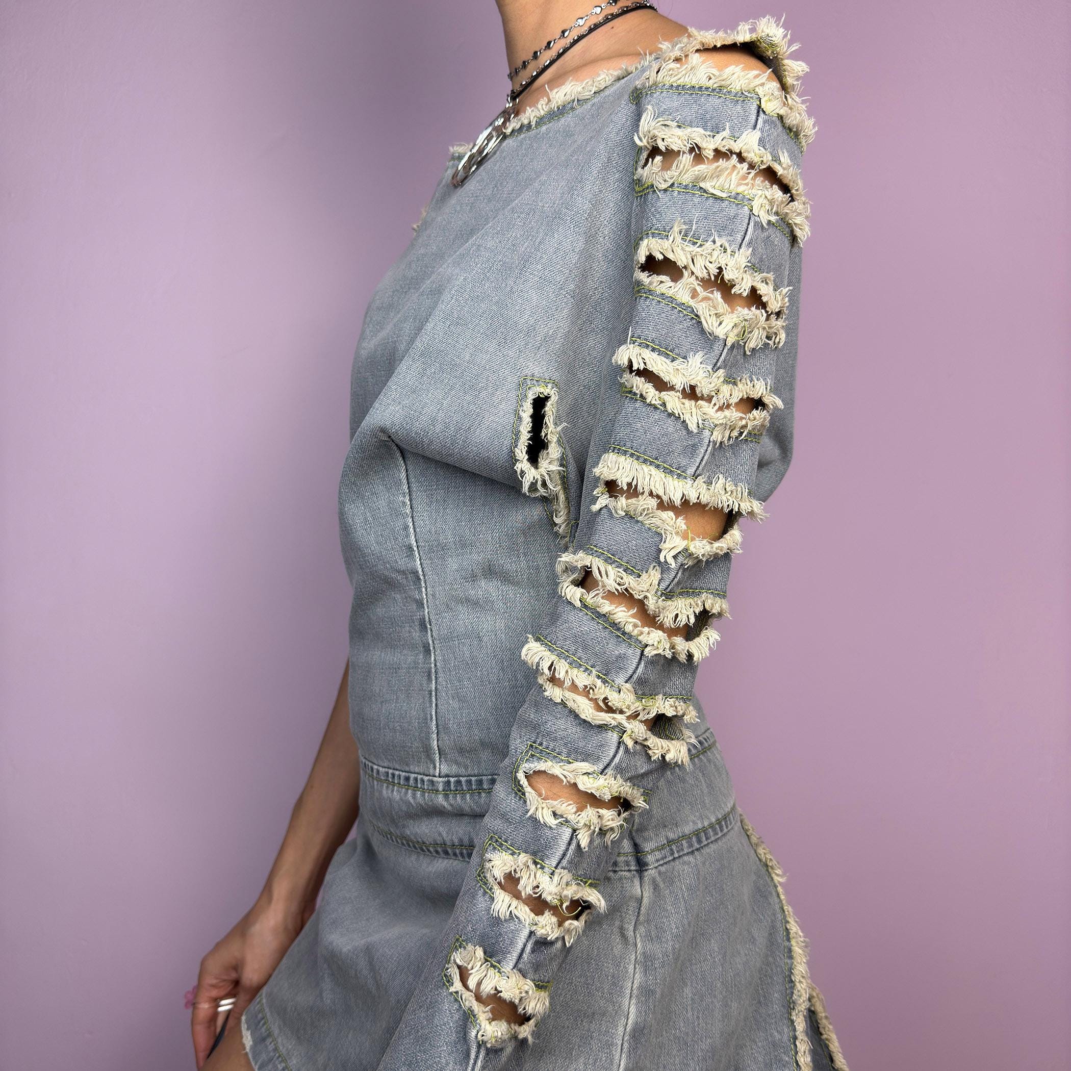 The Y2K Distressed Denim Mini Dress is an edgy statement 2000s piece featuring a raw-cut, asymmetrical design with a structured fit and a side zipper closure. Made from vintage-wash denim, this dress has a deconstructed aesthetic. adult world shop