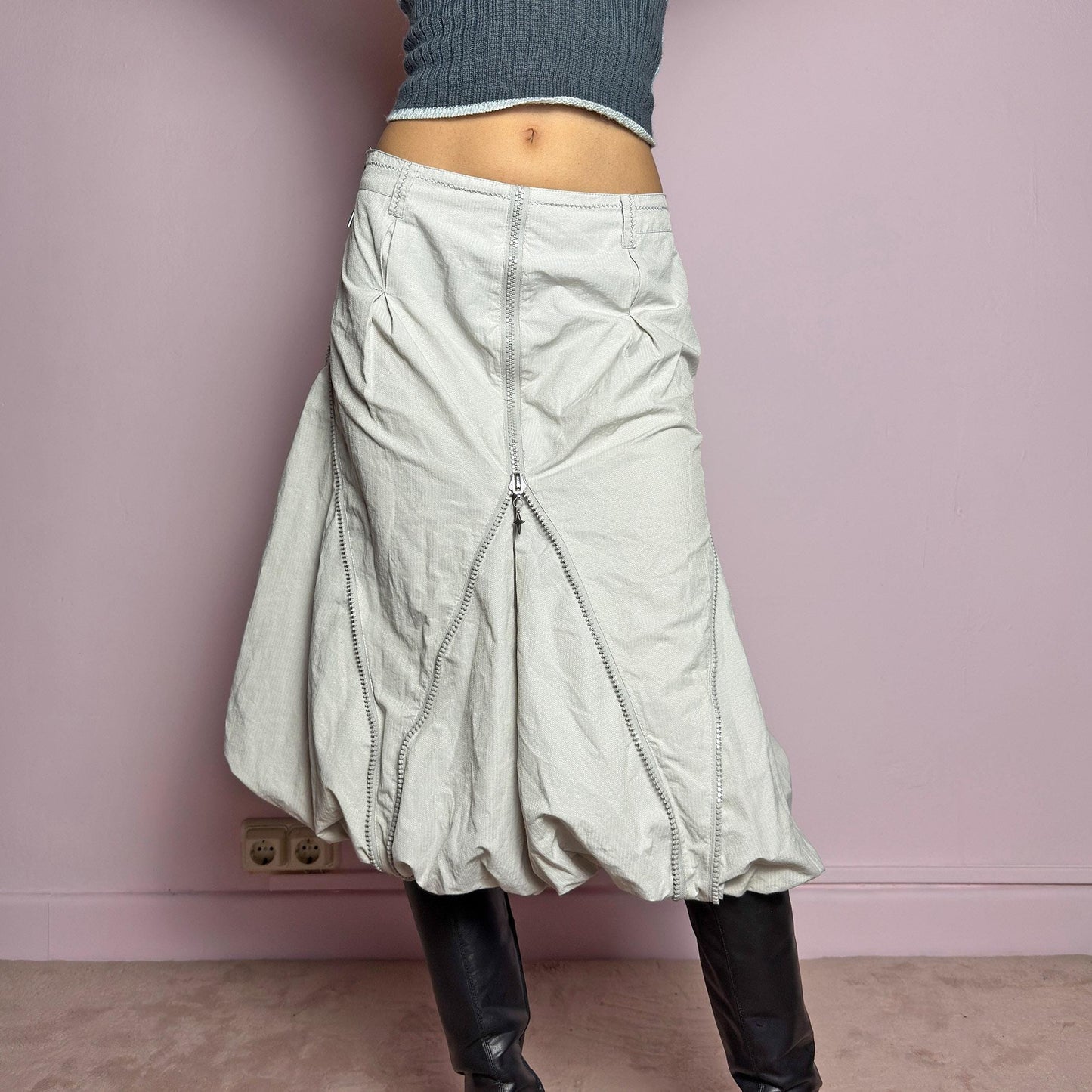 The Y2K Gray Bubble Midi Skirt is a futuristic statement 2000s piece featuring a voluminous bubble silhouette with multiple zipper details that create a dynamic, adjustable shape. Designed with a structured high-rise fit, and a side zipper closure, this skirt is perfect for bold streetwear outfits. adult world shop