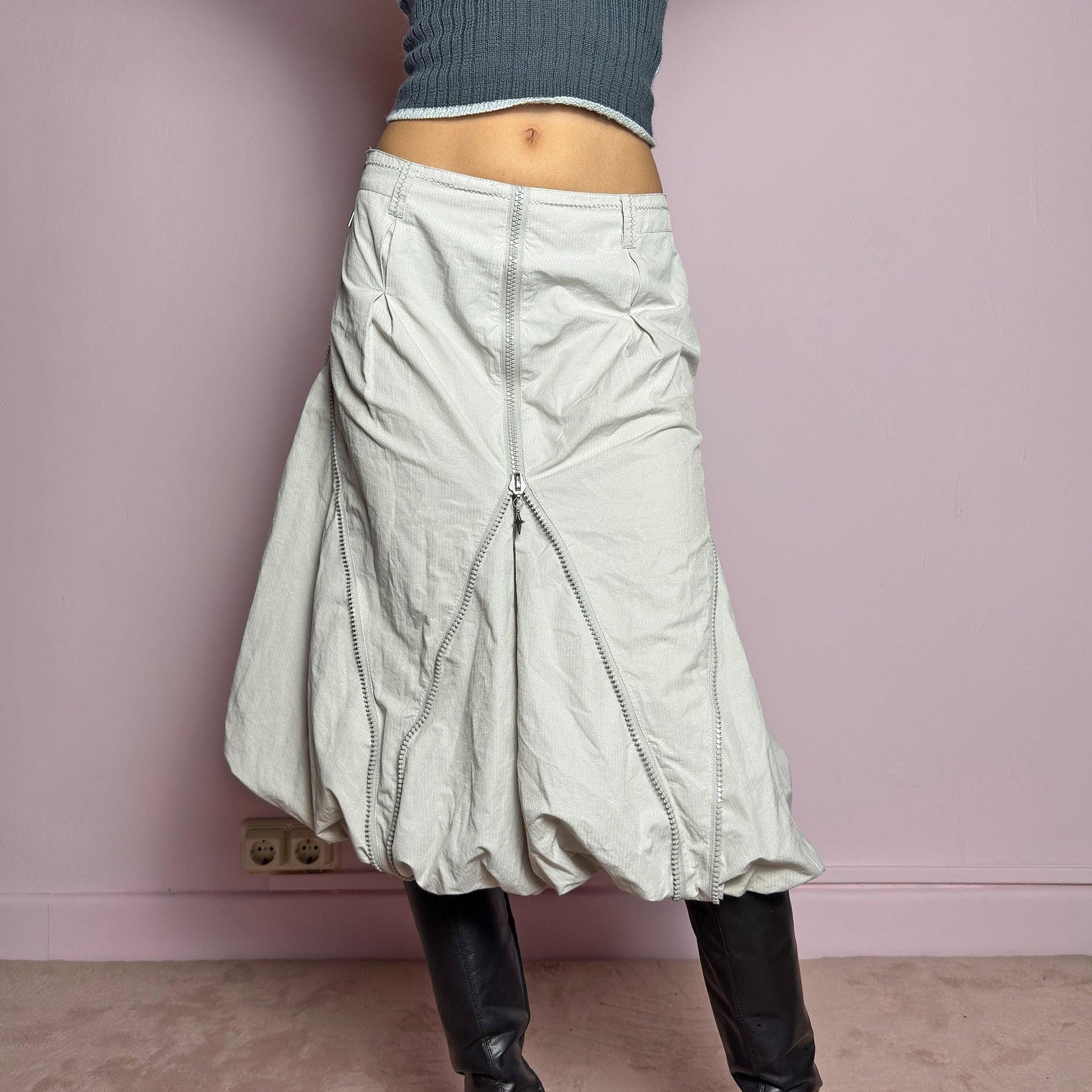 The Y2K Gray Bubble Midi Skirt is a futuristic statement 2000s piece featuring a voluminous bubble silhouette with multiple zipper details that create a dynamic, adjustable shape. Designed with a structured high-rise fit, and a side zipper closure, this skirt is perfect for bold streetwear outfits. adult world shop