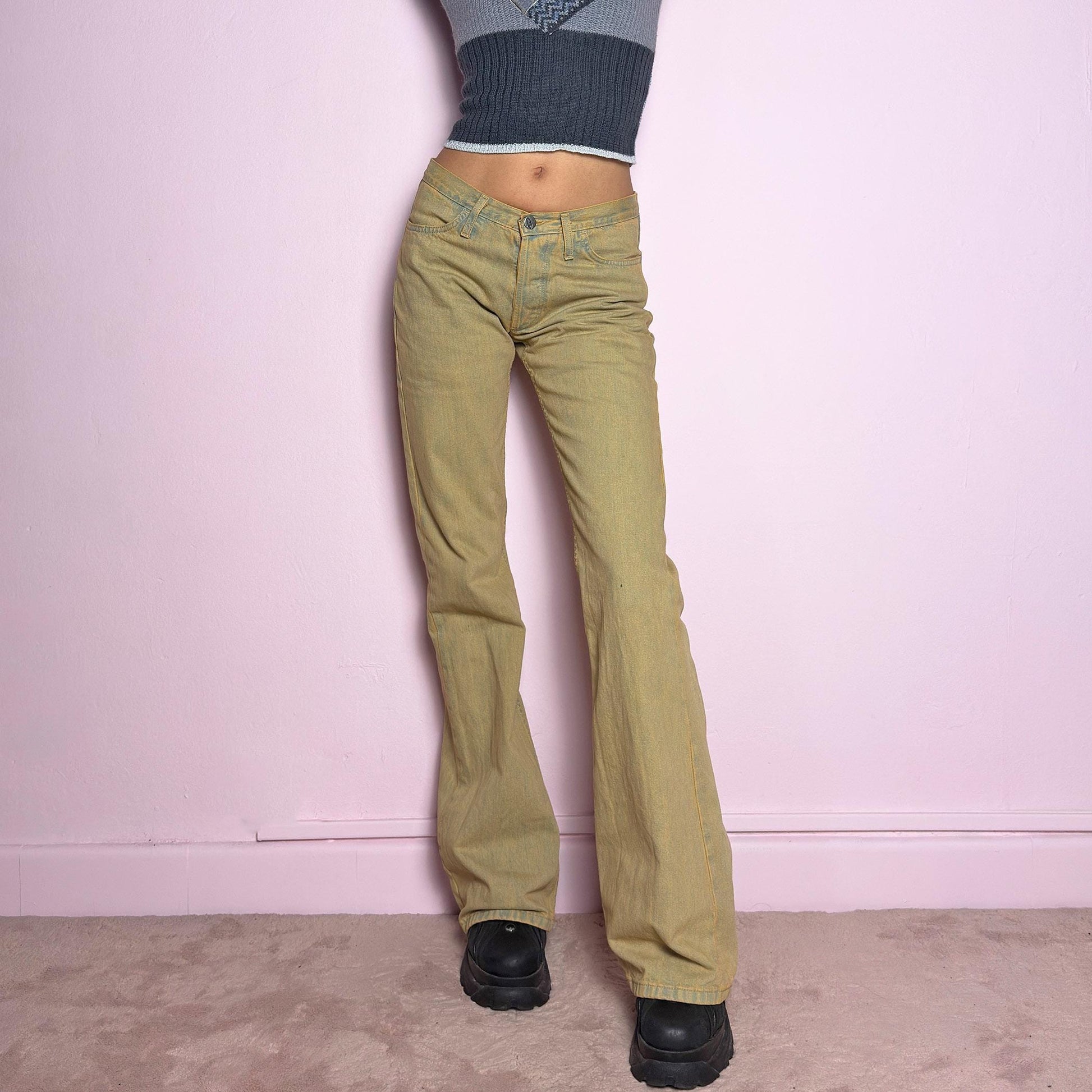 The Y2K Low-Rise Flare Jeans are a vintage 2000s staple featuring a structured denim fabric in a muted earthy tone with a slightly washed effect. Designed with a flattering low-rise fit, button closure, pockets and a flared leg that creates a sleek silhouette, these jeans are perfect for casual outfits. adult world shop