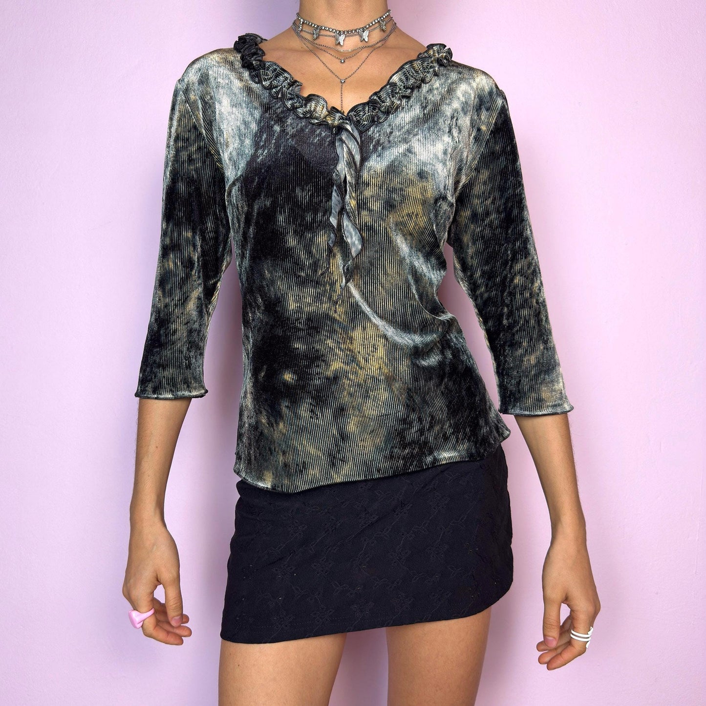 The Y2K Velvet Ruffle Top is a vintage 2000s tie-dye blouse featuring a luxurious ribbed velvet texture in dark olive-gray, beige, and ash tones. Designed with a romantic ruffled neckline and elegant three-quarter sleeves. The ribbed velvet catches the light beautifully, giving off a soft shimmer that makes it perfect for witchy autumn looks, fairy grunge layering, or going-out outfits. Soft, stretchy, and unique — a true statement piece. adult world shop