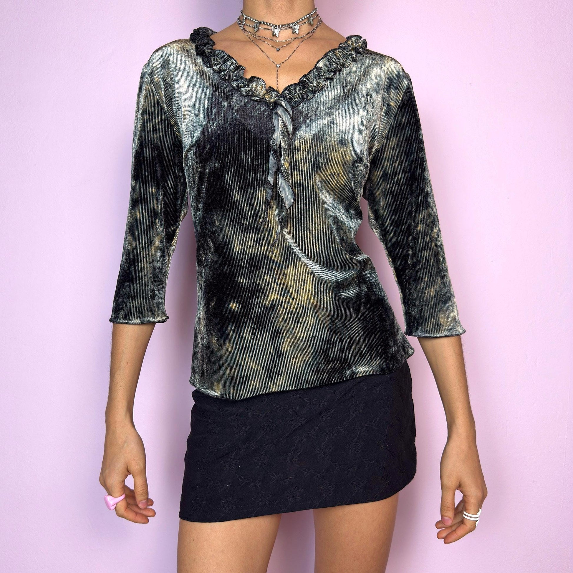 The Y2K Velvet Ruffle Top is a vintage 2000s tie-dye blouse featuring a luxurious ribbed velvet texture in dark olive-gray, beige, and ash tones. Designed with a romantic ruffled neckline and elegant three-quarter sleeves. The ribbed velvet catches the light beautifully, giving off a soft shimmer that makes it perfect for witchy autumn looks, fairy grunge layering, or going-out outfits. Soft, stretchy, and unique — a true statement piece. adult world shop