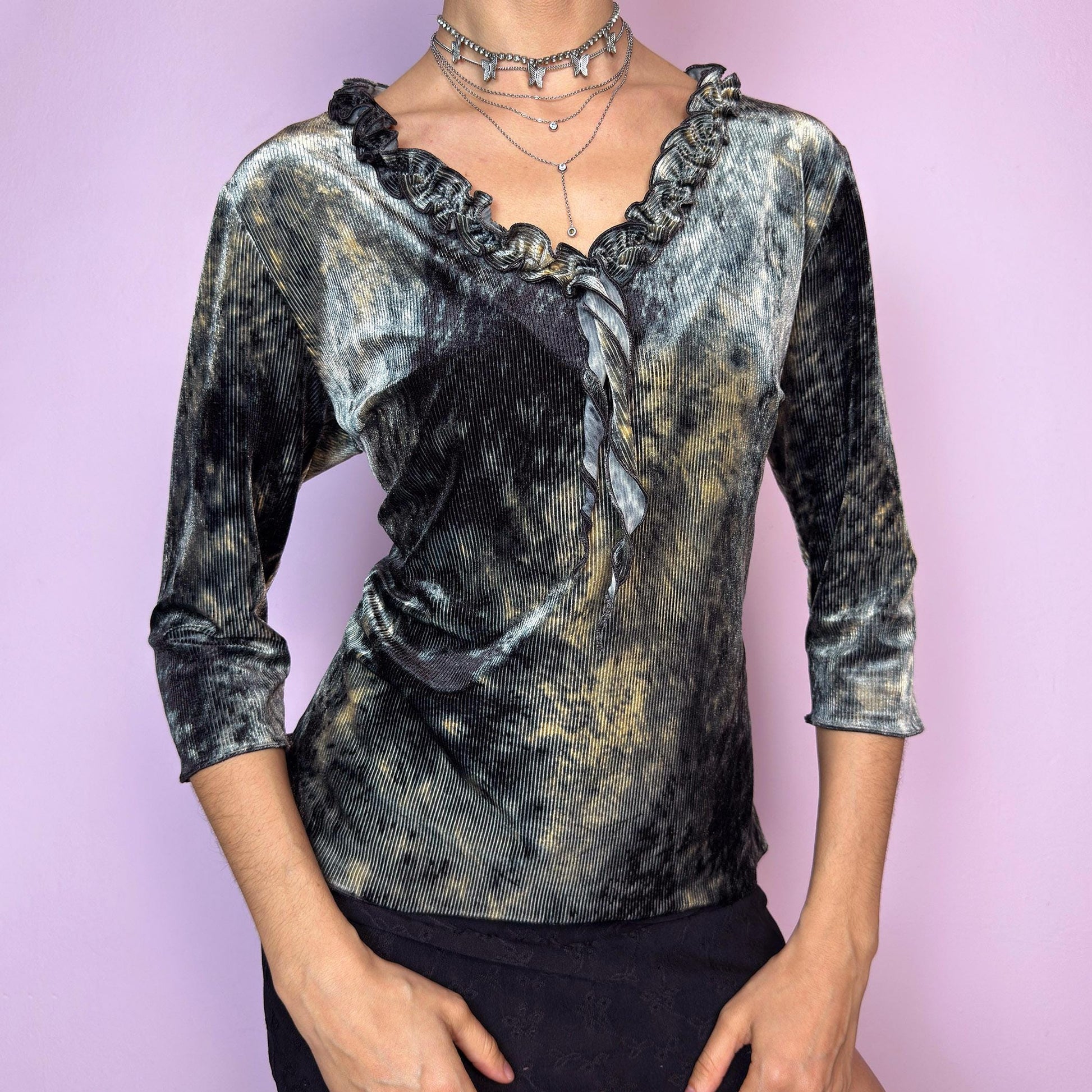 The Y2K Velvet Ruffle Top is a vintage 2000s tie-dye blouse featuring a luxurious ribbed velvet texture in dark olive-gray, beige, and ash tones. Designed with a romantic ruffled neckline and elegant three-quarter sleeves. The ribbed velvet catches the light beautifully, giving off a soft shimmer that makes it perfect for witchy autumn looks, fairy grunge layering, or going-out outfits. Soft, stretchy, and unique — a true statement piece. adult world shop