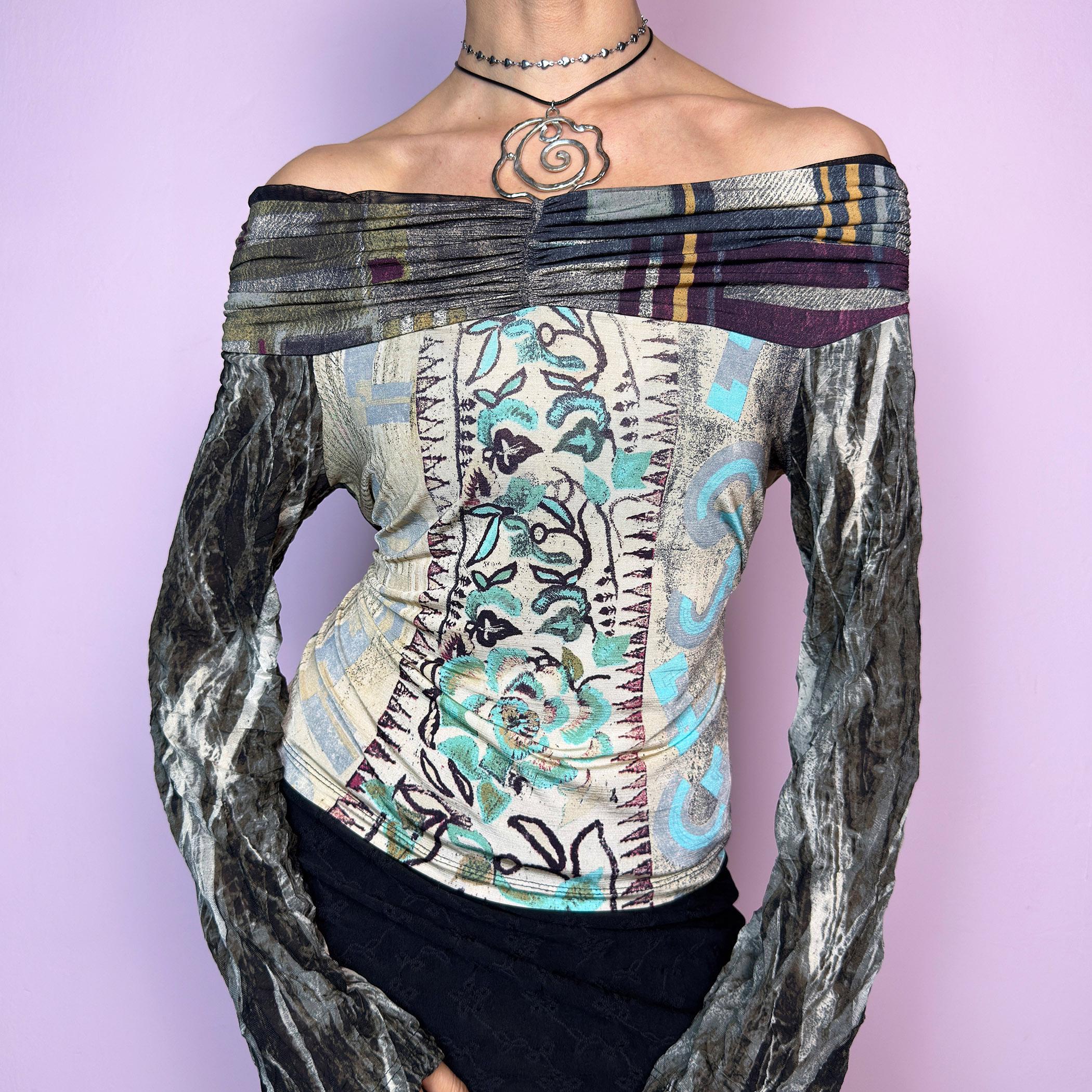 The Y2K Art Print Top is a vintage 2000s off-the-shoulder long sleeve designed by Legatte Jeans. This artsy piece features a unique patchwork-style mixed print with floral, stripe, and abstract motifs in a moody palette of cream, sage, burgundy, and metallic gray. The body is made from soft, stretchy fabric, while the semi-sheer mesh sleeves add a delicate contrast. Pleated details along the neckline elevate its sculptural silhouette. adult world shop