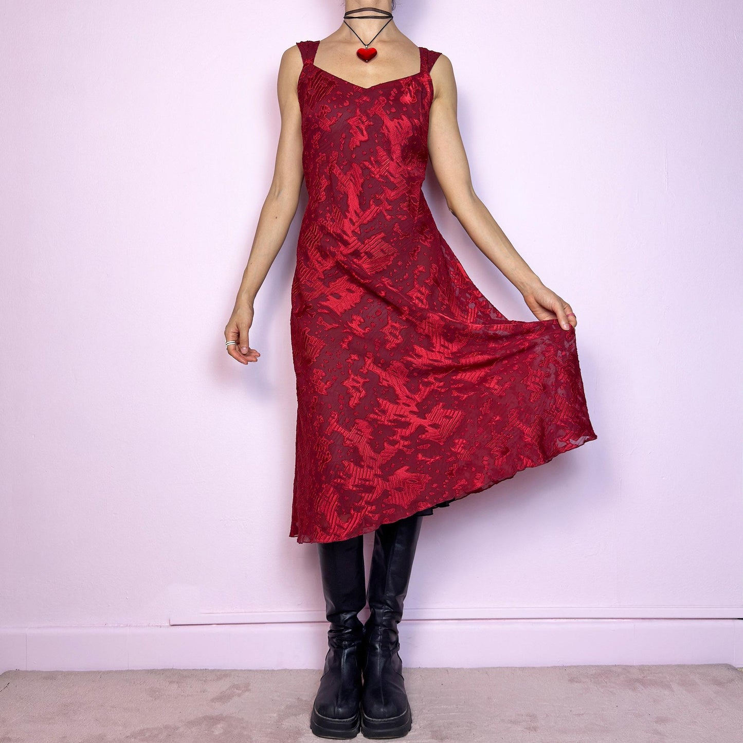 The Vintage 90s Maroon Textured Midi Dress is a romantic and striking piece in a rich maroon tone with abstract textured patterns and a sheer overlay. Designed with wide straps, a flattering sweetheart neckline, and a flowy midi-length cut. The semi-sheer fabric adds depth while the inner lining provides comfort. Perfect for formal events, romantic nights, or gothic glam looks. Elegant, timeless, and effortlessly dramatic. Excellent vintage condition.