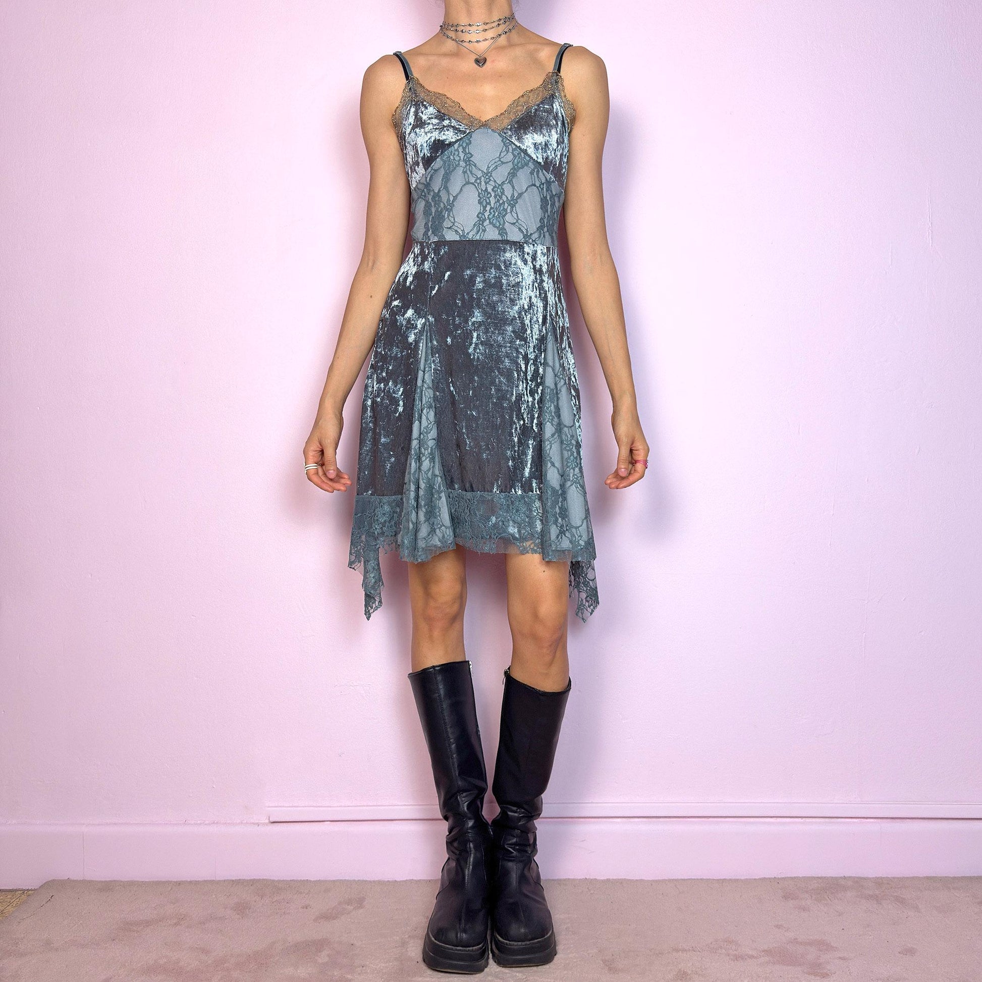 This vintage 2000s stretchy slip dress is cut from cool grey velvet with sheer lace panels and scalloped trim. It features a V-neckline, thin adjustable straps, and an asymmetric handkerchief hem. The paneled construction sculpts the waist and includes a hidden side zipper. Perfect for summer. A romantic Y2K piece with whimsical fairycore undertones. Great vintage condition.