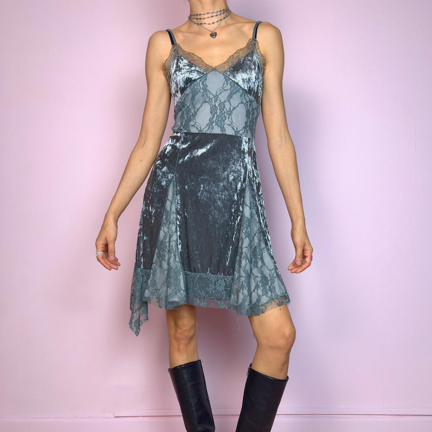 This vintage 2000s stretchy slip dress is cut from cool grey velvet with sheer lace panels and scalloped trim. It features a V-neckline, thin adjustable straps, and an asymmetric handkerchief hem. The paneled construction sculpts the waist and includes a hidden side zipper. Perfect for summer. A romantic Y2K piece with whimsical fairycore undertones. Great vintage condition.