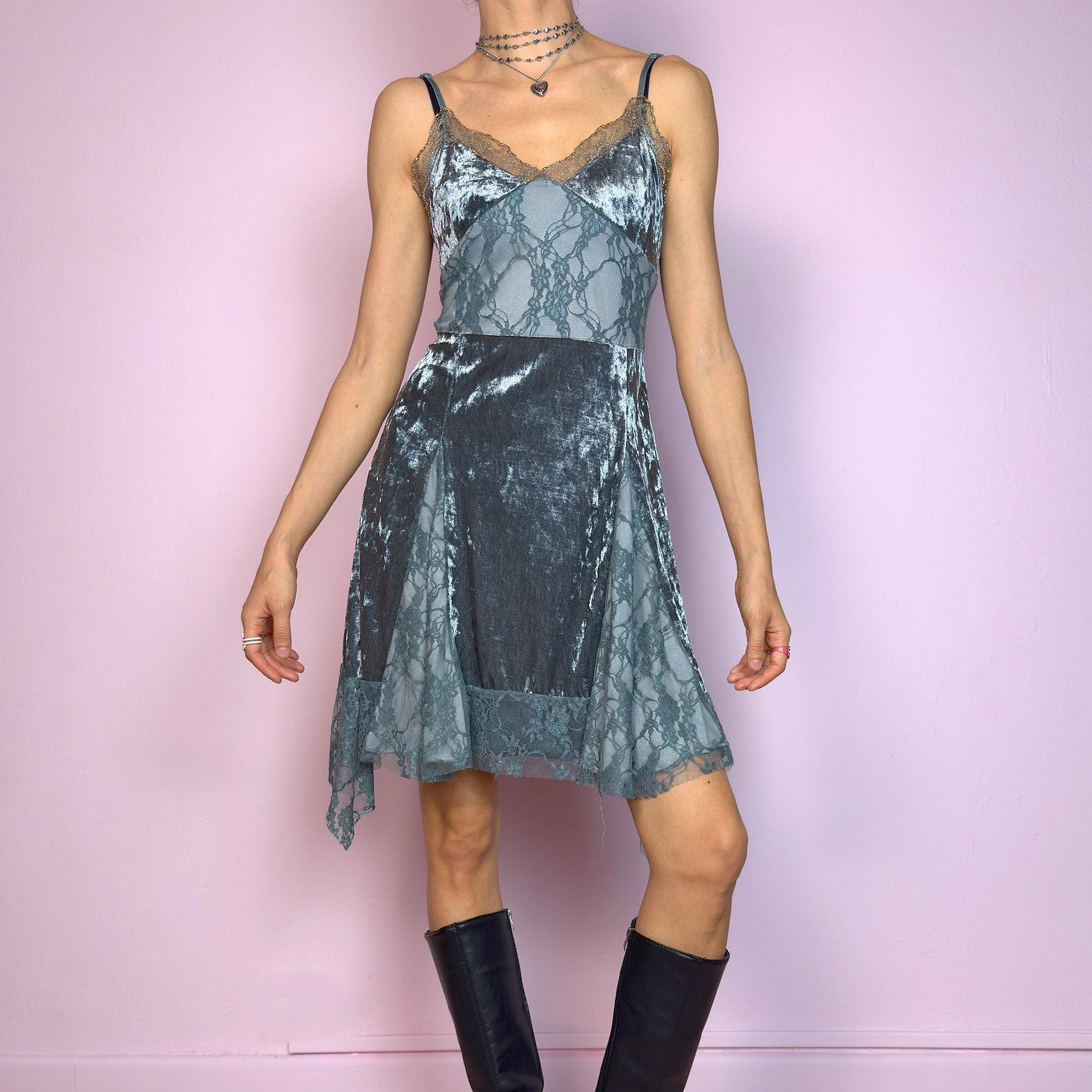 This vintage 2000s stretchy slip dress is cut from cool grey velvet with sheer lace panels and scalloped trim. It features a V-neckline, thin adjustable straps, and an asymmetric handkerchief hem. The paneled construction sculpts the waist and includes a hidden side zipper. Perfect for summer. A romantic Y2K piece with whimsical fairycore undertones. Great vintage condition.