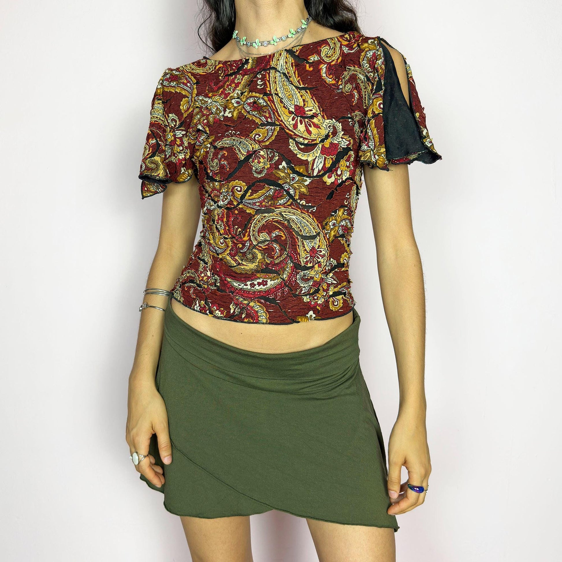 This vintage 2000s crinkle mesh top stuns with yellow-gold paisley prints on a rich maroon base and a dramatic split short sleeve. Ideal for summer nights, art parties, or elegant outdoor dinner looks. A rare, textile-rich piece with gypsy-bohemian undertones and free-spirited dancing energy. Made of stretch polyester blend. Great vintage condition.