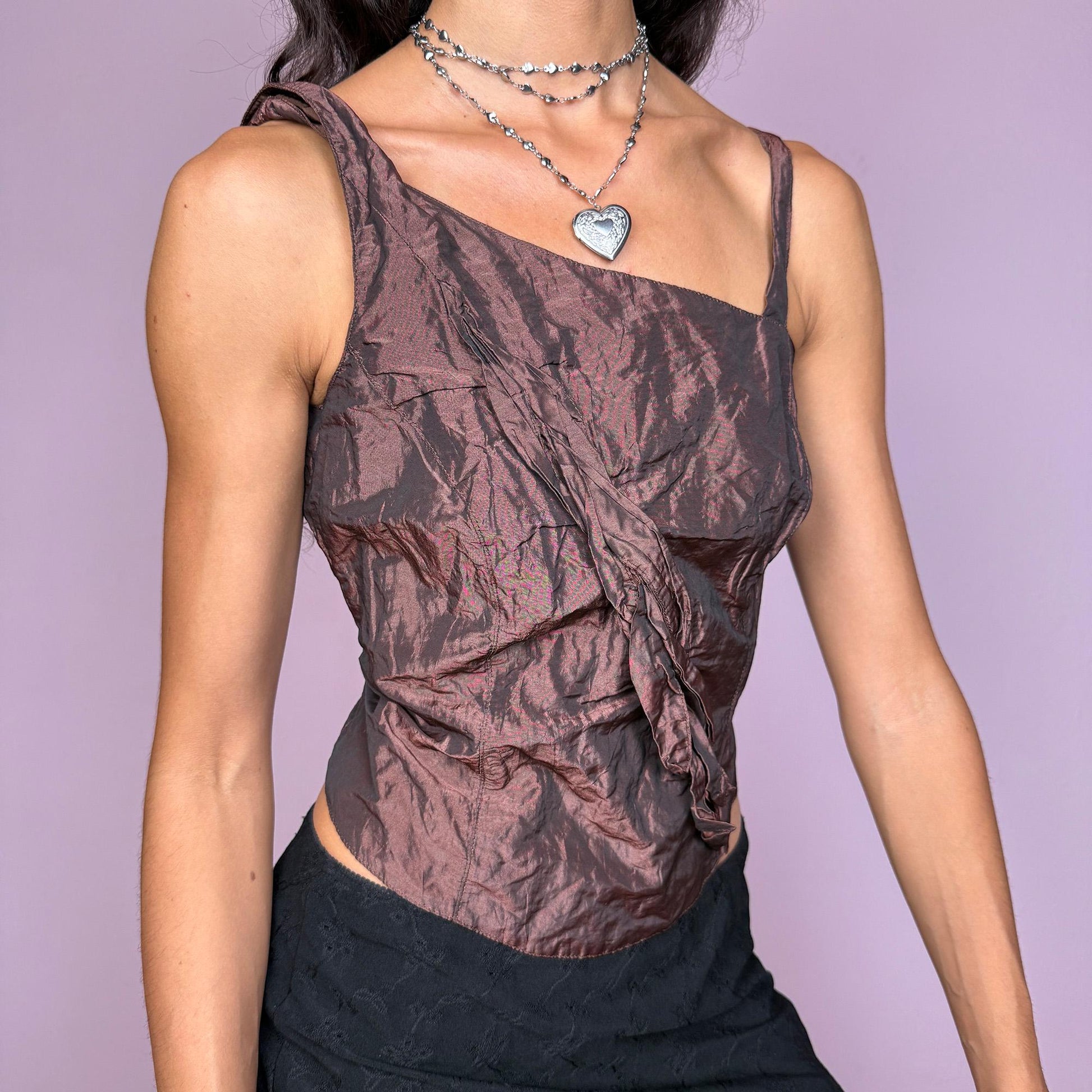 This vintage 2000s top features an iridescent brown crinkle texture with an asymmetric neckline and sculptural front appliqué. Designed for evening wear with a side zip closure and structured waist, this fairy-touched deconstructed blouse is ideal for weddings, formal nights, or whimsical events. A rare archival event piece for elevated styling. Made from non-stretch polyester. Excellent vintage condition.