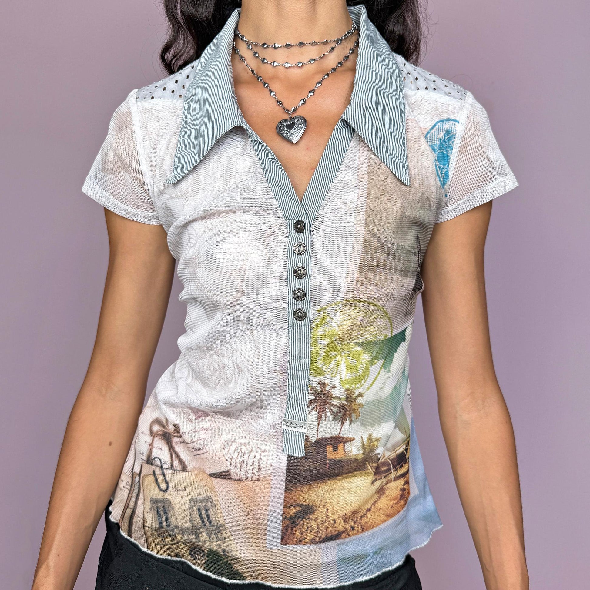 This vintage 2000s French mesh top features a unique landscape-abstract print, short sleeves, and a sharp striped collar. Designed with a button front, semi-sheer stretch fabric, and a striped back panel, it captures the deconstructed city aesthetic and weird-girl Y2K vibe. Perfect for casual summer outfits or layered statement styling. Made from a polyester and cotton stretch blend. Great vintage condition.