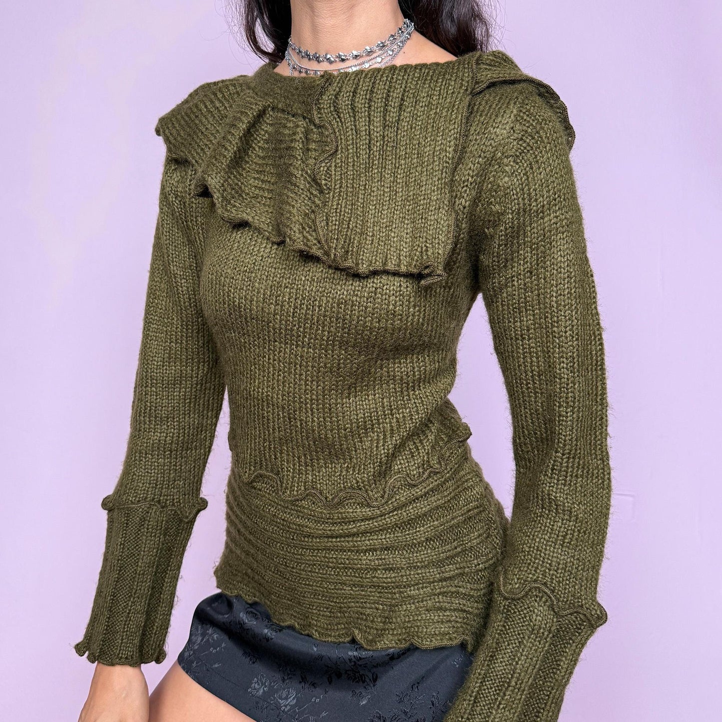 This vintage 2000s green sweater features a sculptural folded collar and wavy hems. This soft and warm mohair–acrylic blend piece embodies Y2K fairycore charm with forest-inspired elegance. Perfect for autumn layering or cozy winter styling—a whimsical archive knit. Made from mohair acrylic blend. Excellent vintage condition.