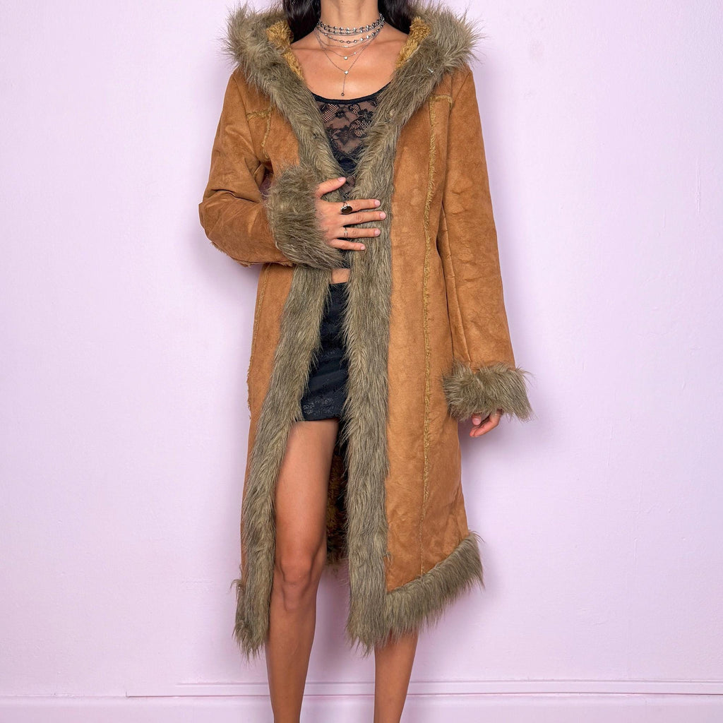 This vintage 2000s brown faux suede long coat features a hooded Afghan Penny Lane silhouette with plush beige faux fur trim and cuffs. Fitted through the body with hidden hook closure and side pockets, it delivers a warm, bohemian look perfect for autumn and winter layering. Made from faux suede with faux fur lining. Great vintage condition.