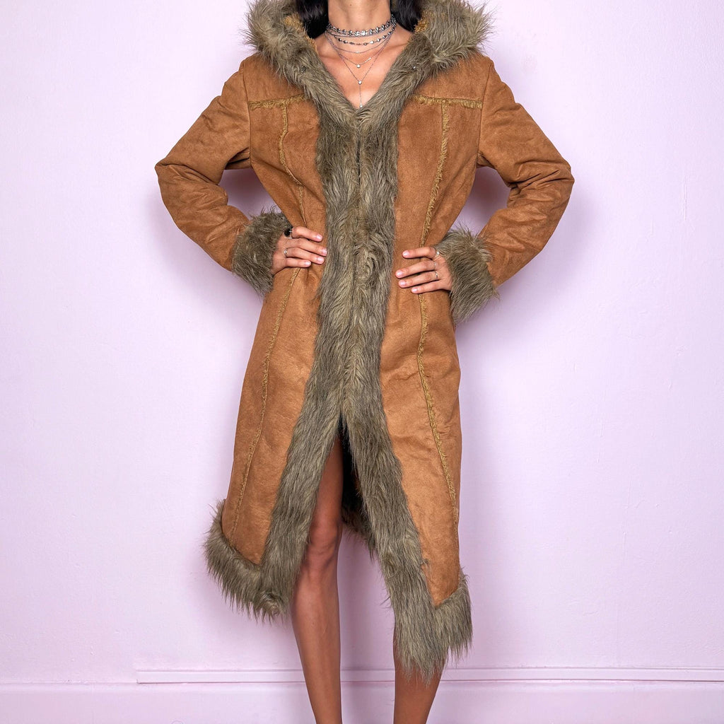This vintage 2000s brown faux suede long coat features a hooded Afghan Penny Lane silhouette with plush beige faux fur trim and cuffs. Fitted through the body with hidden hook closure and side pockets, it delivers a warm, bohemian look perfect for autumn and winter layering. Made from faux suede with faux fur lining. Great vintage condition.