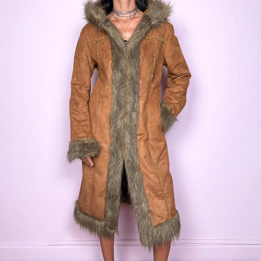 This vintage 2000s brown faux suede long coat features a hooded Afghan Penny Lane silhouette with plush beige faux fur trim and cuffs. Fitted through the body with hidden hook closure and side pockets, it delivers a warm, bohemian look perfect for autumn and winter layering. Made from faux suede with faux fur lining. Great vintage condition.