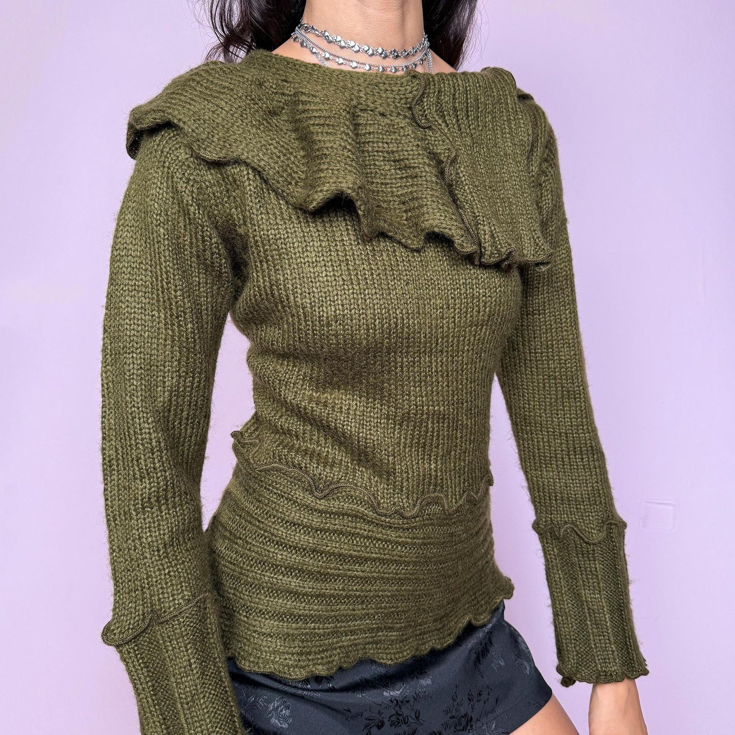 This vintage 2000s green sweater features a sculptural folded collar and wavy hems. This soft and warm mohair–acrylic blend piece embodies Y2K fairycore charm with forest-inspired elegance. Perfect for autumn layering or cozy winter styling—a whimsical archive knit. Made from mohair acrylic blend. Excellent vintage condition.