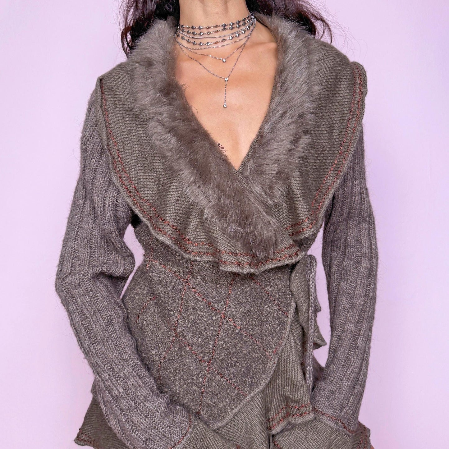 This vintage 2000s taupe gray-brown ruffle wrap cardigan features a dramatic faux fur collar, bell sleeves, and a tie-front waist. Crafted in a mohair–wool–acrylic–polyester blend, it offers plush warmth and sculptural drape. The asymmetrical hem and contrast stitching evoke Y2K fairycore romance with a cozy, whimsical twist. Perfect for winter layering or statement street styling. A rare collector’s knit jacket. Made from mohair wool acrylic polyester blend. Excellent vintage condition.