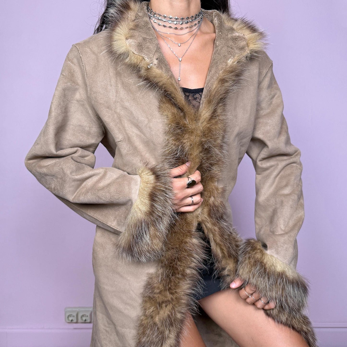 This vintage beige Penny Lane coat features a real fur trim along the collar and cuffs, faux suede body, hook closure, and side pockets. A 70s-inspired Afghan silhouette that channels boho elegance and winter romance, perfect for statement cold-weather styling. Great vintage condition.