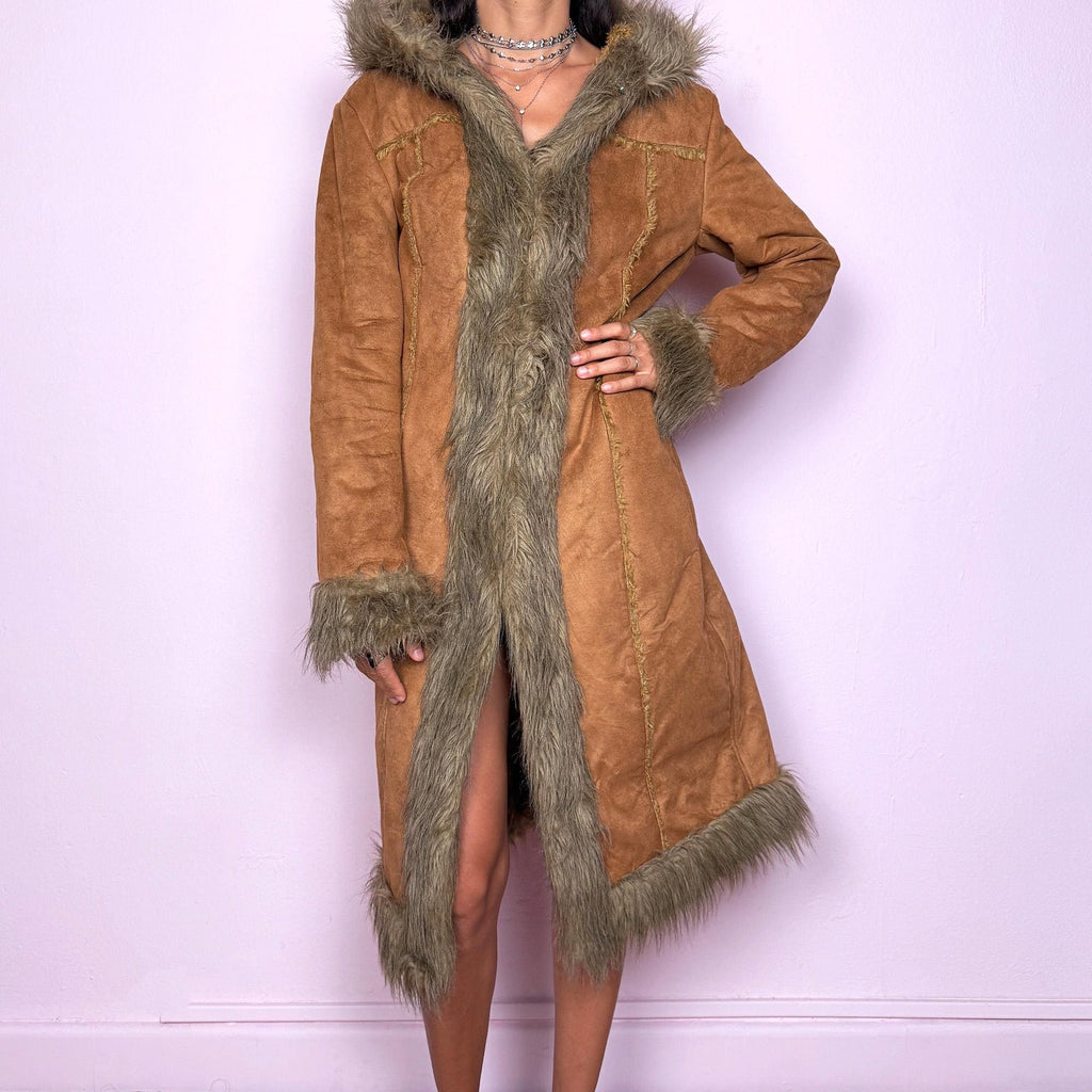 This vintage 2000s brown faux suede long coat features a hooded Afghan Penny Lane silhouette with plush beige faux fur trim and cuffs. Fitted through the body with hidden hook closure and side pockets, it delivers a warm, bohemian look perfect for autumn and winter layering. Made from faux suede with faux fur lining. Great vintage condition.
